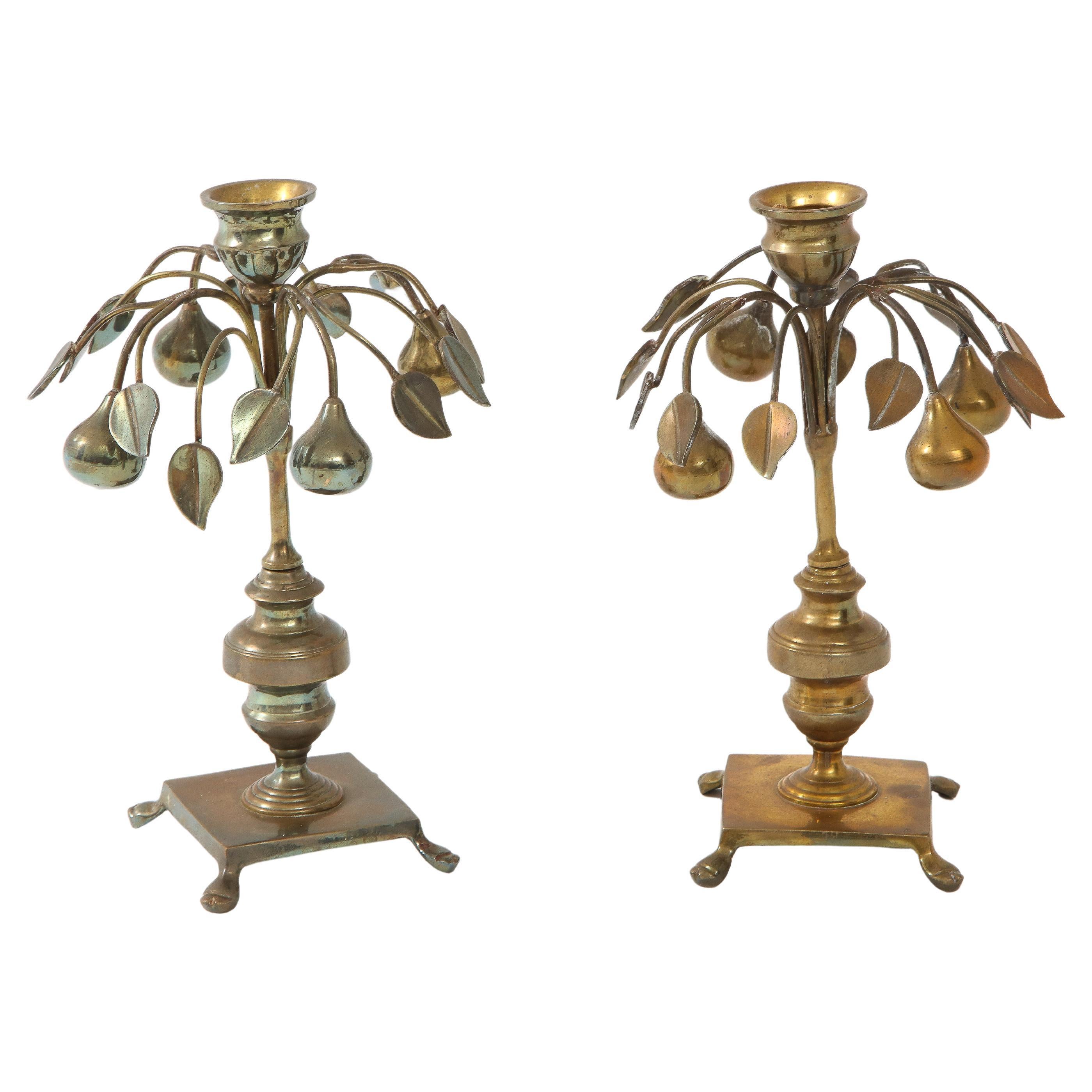 Pair of silver plate stylized pear and leaf motof candlesticks on a traditional central post. Stamped Mottahedeh. We have left the patina on the silver, could be polished.