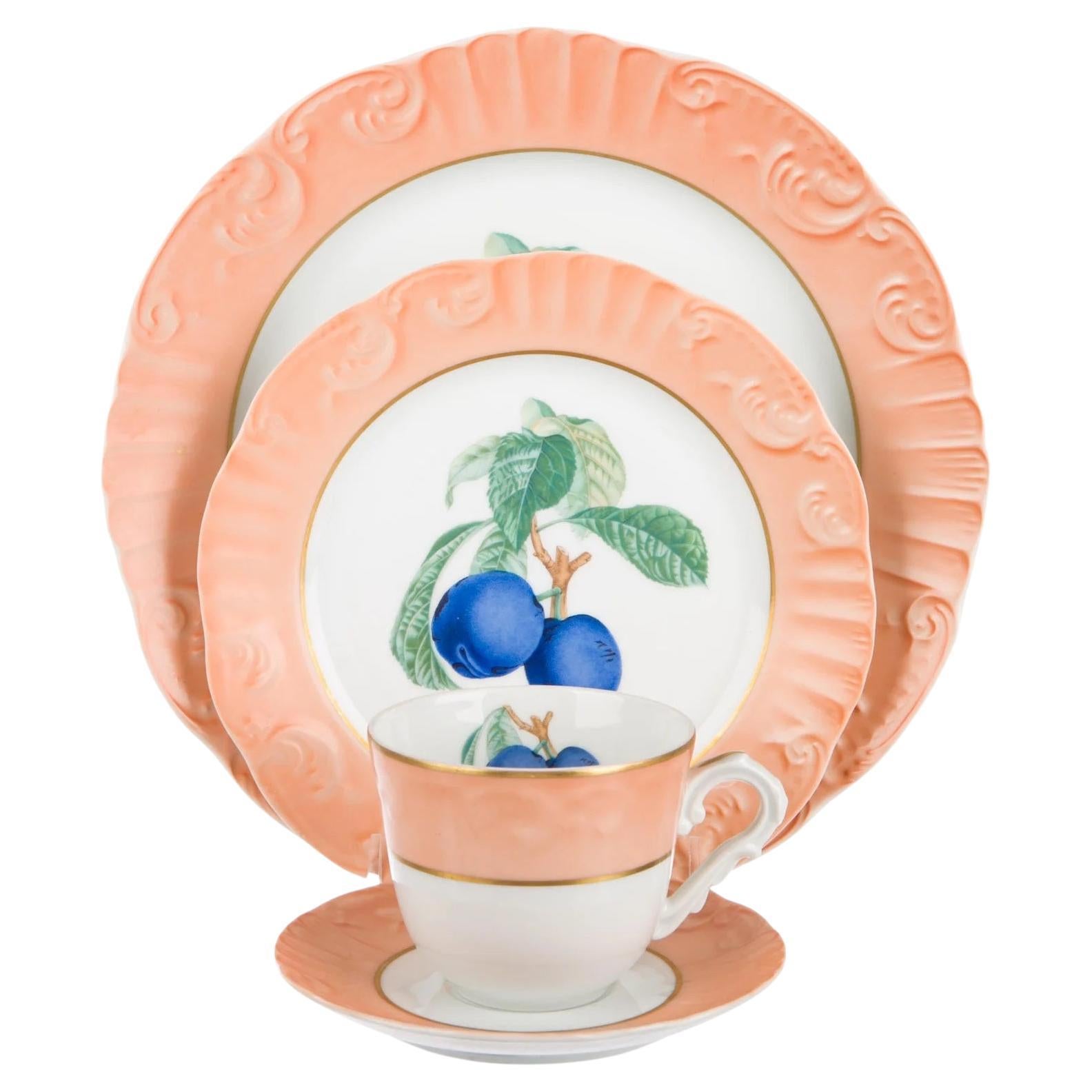 A 24 piece dinnerware set in the Summer Fruit pattern by Mottahedeh. 

Features a peach and white multicolor design with fruit motif at centers, scalloped edges at plates, gilt accents and brand stamp at undersides. 

Includes the following 24