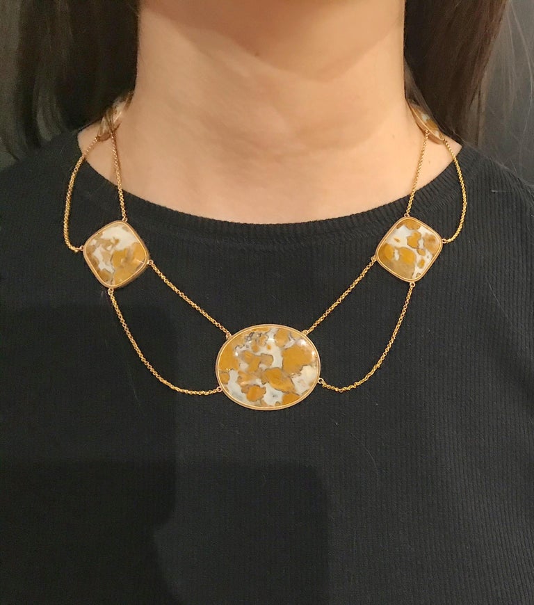 Stunning Swag Necklace featuring Natural translucent Mottled Agates with milky translucence and Earth tone designs securely  framed in 14 Karat Gold. Consisting of 4 swags of oval and square form and a large center oval swag, all attached to a link