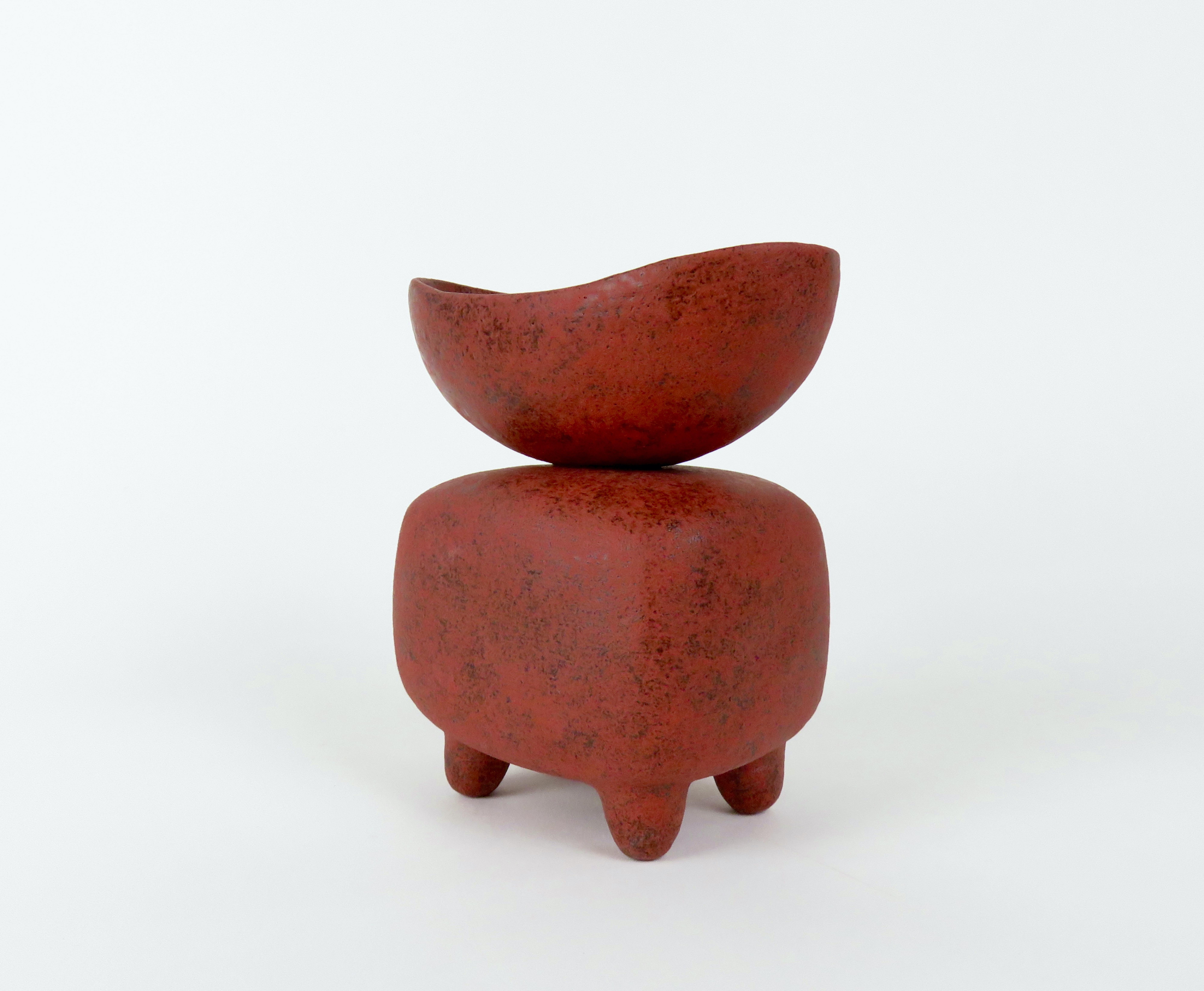 A small hand built ceramic sculpture in Mottled Red, the first piece in this color. The process began with a dark brown clay body and Inspiration. In regal, holy or ritual offerings, a cup or chalice is often used during the ceremony. Here the cup