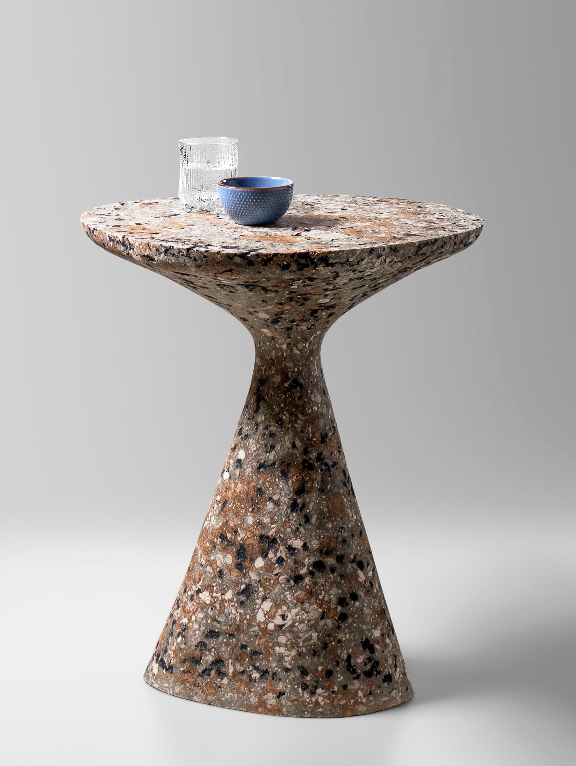 Mottled Side Table by Kasanai
Dimensions: D 46 x H 61 cm.
Materials: Concrete, recycled cardboard, glue, paint.
6 kg.

The fusion of sturdiness and elegance, along with the blend of archaism and modernity. More than just a surface for placing