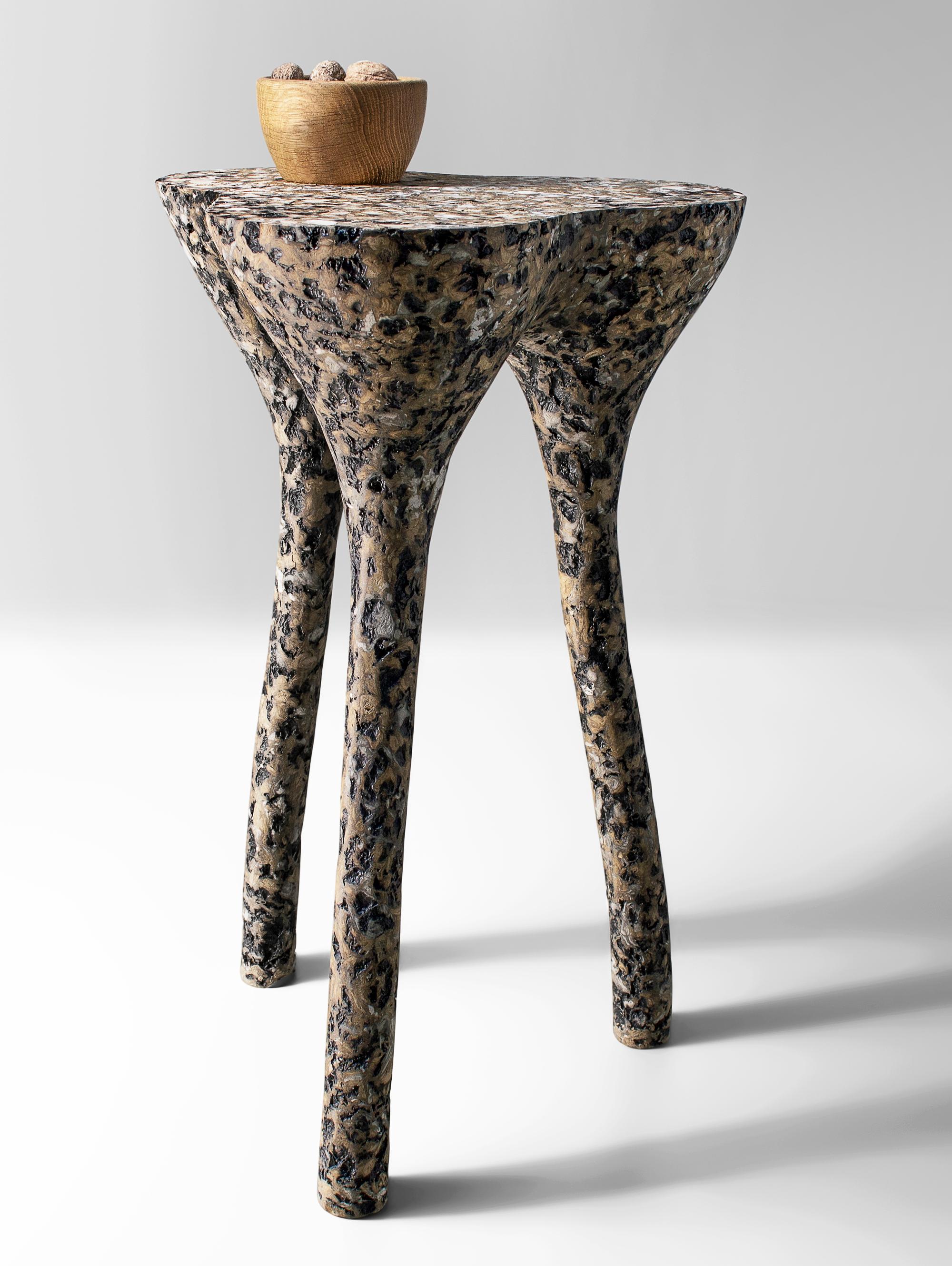 Mottled Tripod Side Table by Kasanai
Dimensions: D 38 x H 65 cm.
Materials: Concrete, recycled cardboard, glue, paint.
6 kg.

The fusion of sturdiness and elegance, along with the blend of archaism and modernity. More than just a surface for placing