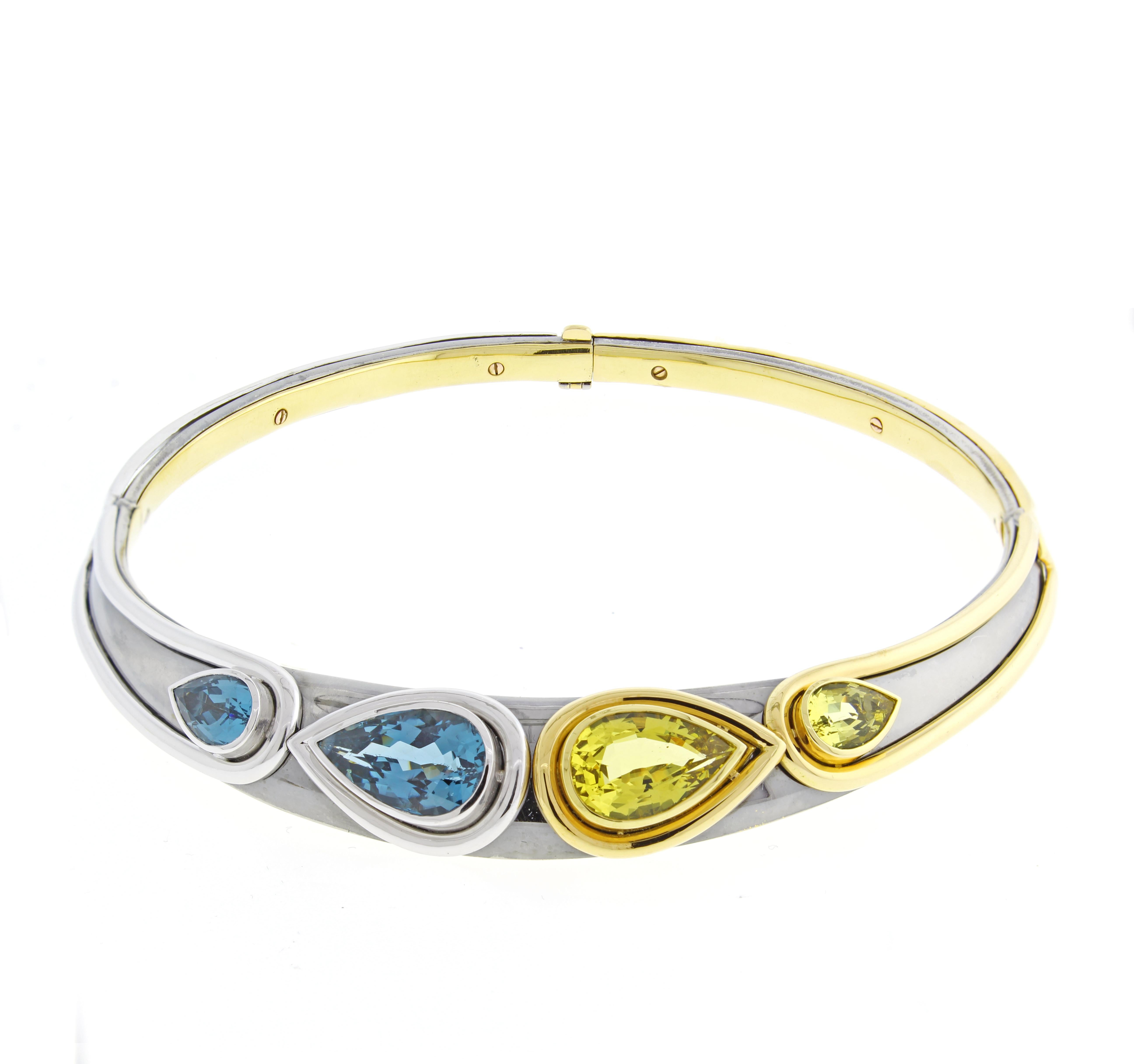 From the House of Mouawad, a blue topaz and golden beryl neck collar and matching bracelet. The stet features pear shape blue topaz and beryl set in white, yellow and rhodium 18 karat gold. 
223 grams. The necklace has inside diameter is 4 ¾ x 4½ ,
