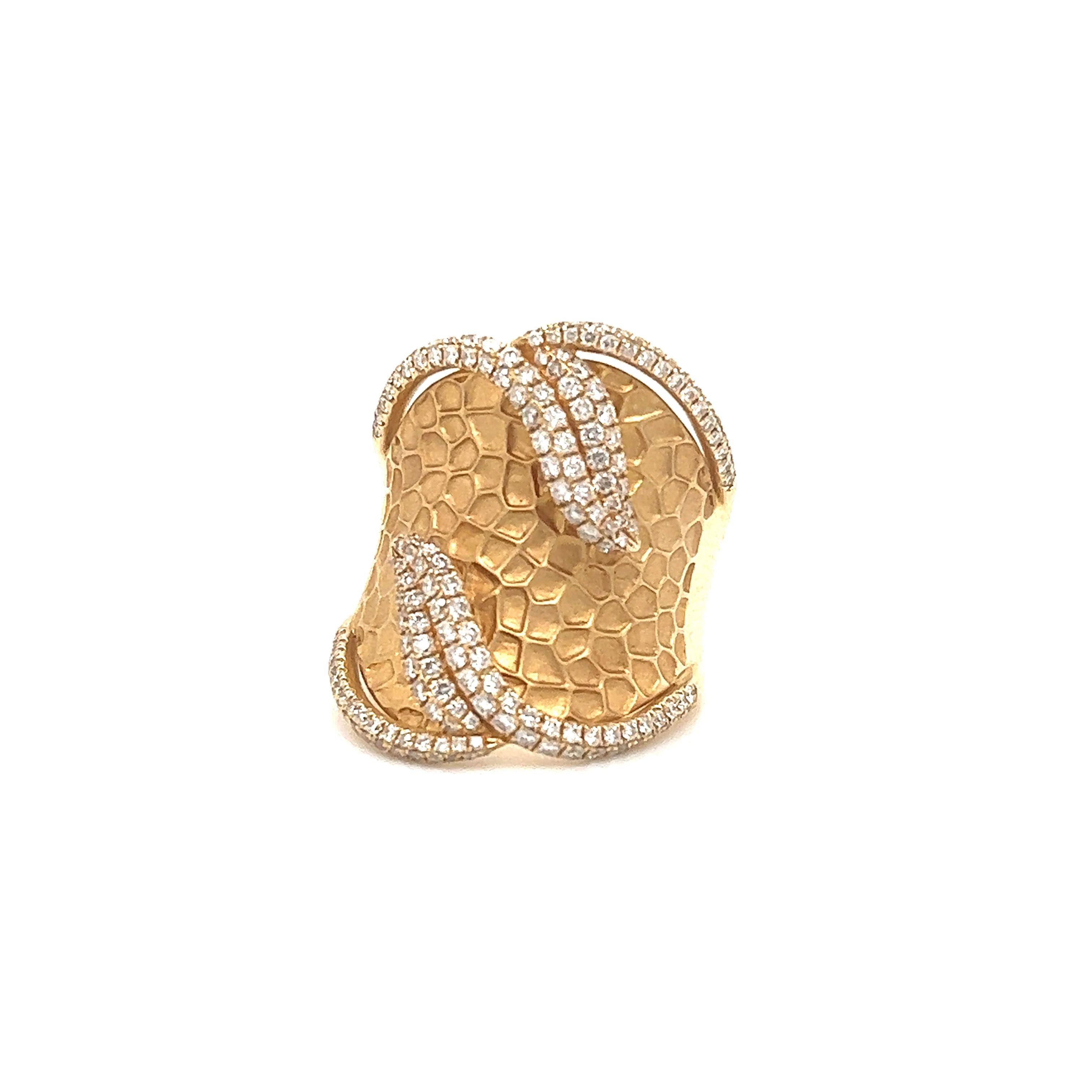 Fantastic design seen on this designer ring by Mouawad. The ring is crafted in 18k yellow gold and shows details throughout. The ring is a wide band design as it measures 23.5 mm on the front and tapers down to 6.5 mm at the base of the shank. The
