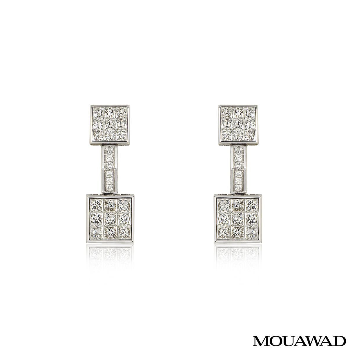 A sparkly pair of 18k white gold diamond earrings by Mouawad. Each earring comprise of 2 square motifs with a bar connecting the two. The square motifs have 9 princess cut diamonds in each and the bar features 6 round brilliant cut diamonds in a