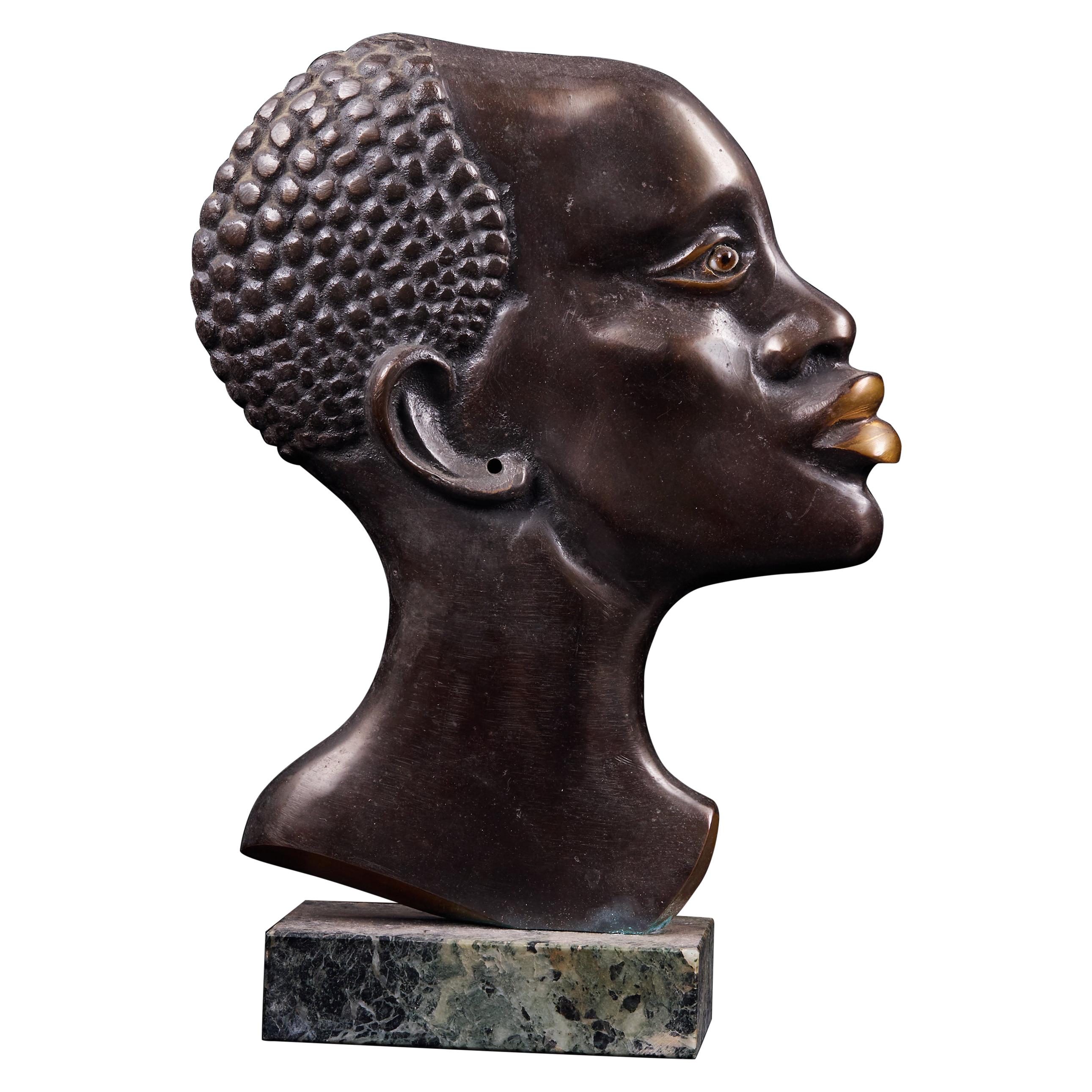 Moulded Copper Alloy Head of an African Figure with a Stone Base