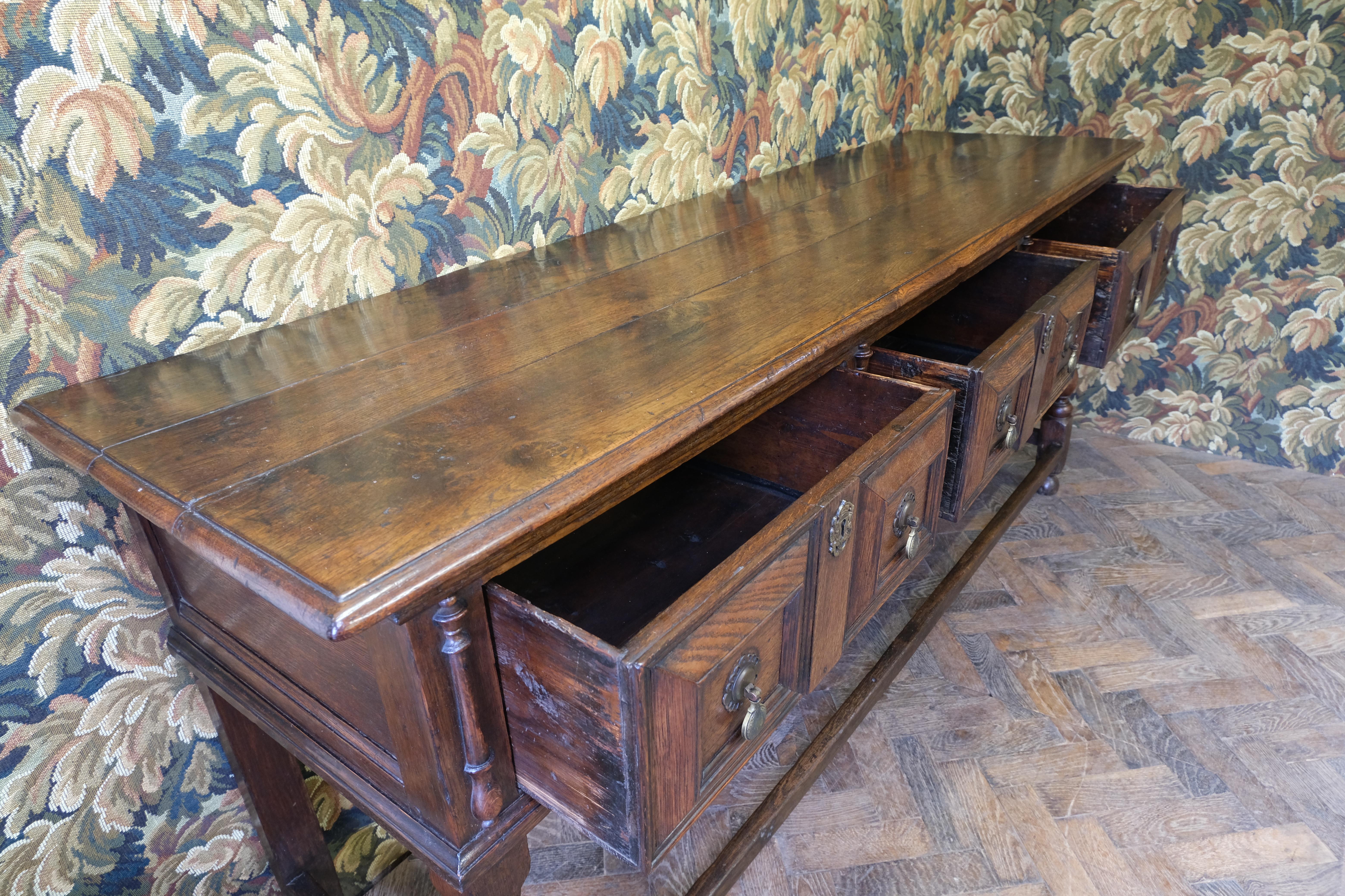Hutton Clarke Antiques is delighted to present a distinguished 18th-century oak dresser base, dating back to circa 1750. This exquisite piece showcases a solid oak construction, renowned for its enduring strength and captivating grain, which has