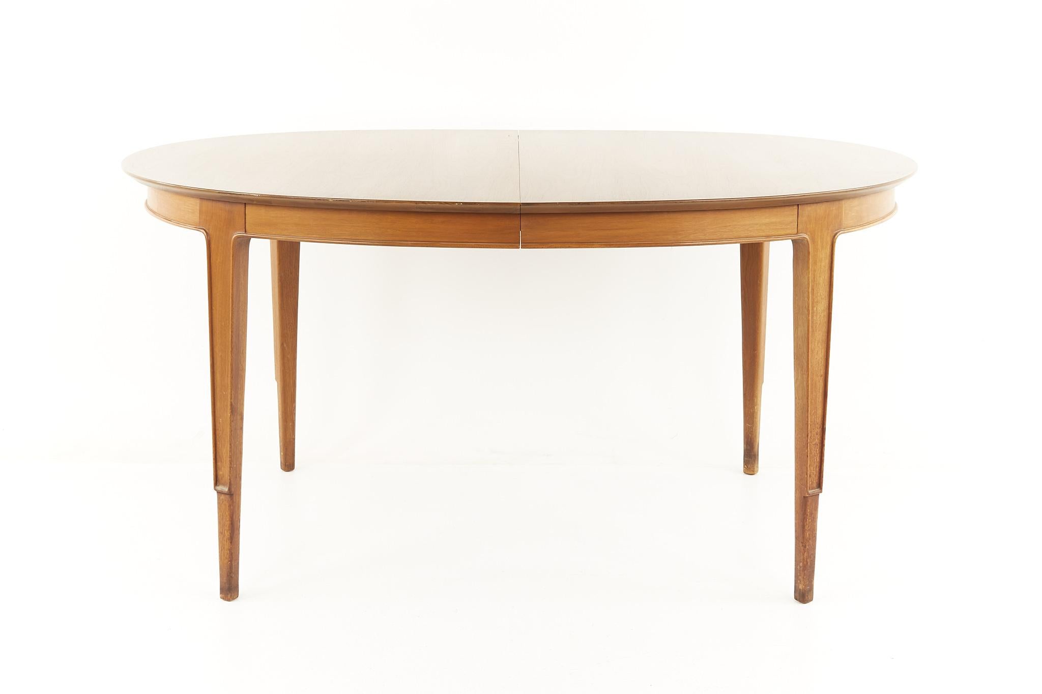 Mount Airy Janus mid century dining table with 2 leaves 

This table measures: 60 wide x 40 deep x 29.5 inches high, with a chair clearance of 26.75 inches high, each of the 2 leaves are 18 inches wide, making a maximum table width of 96