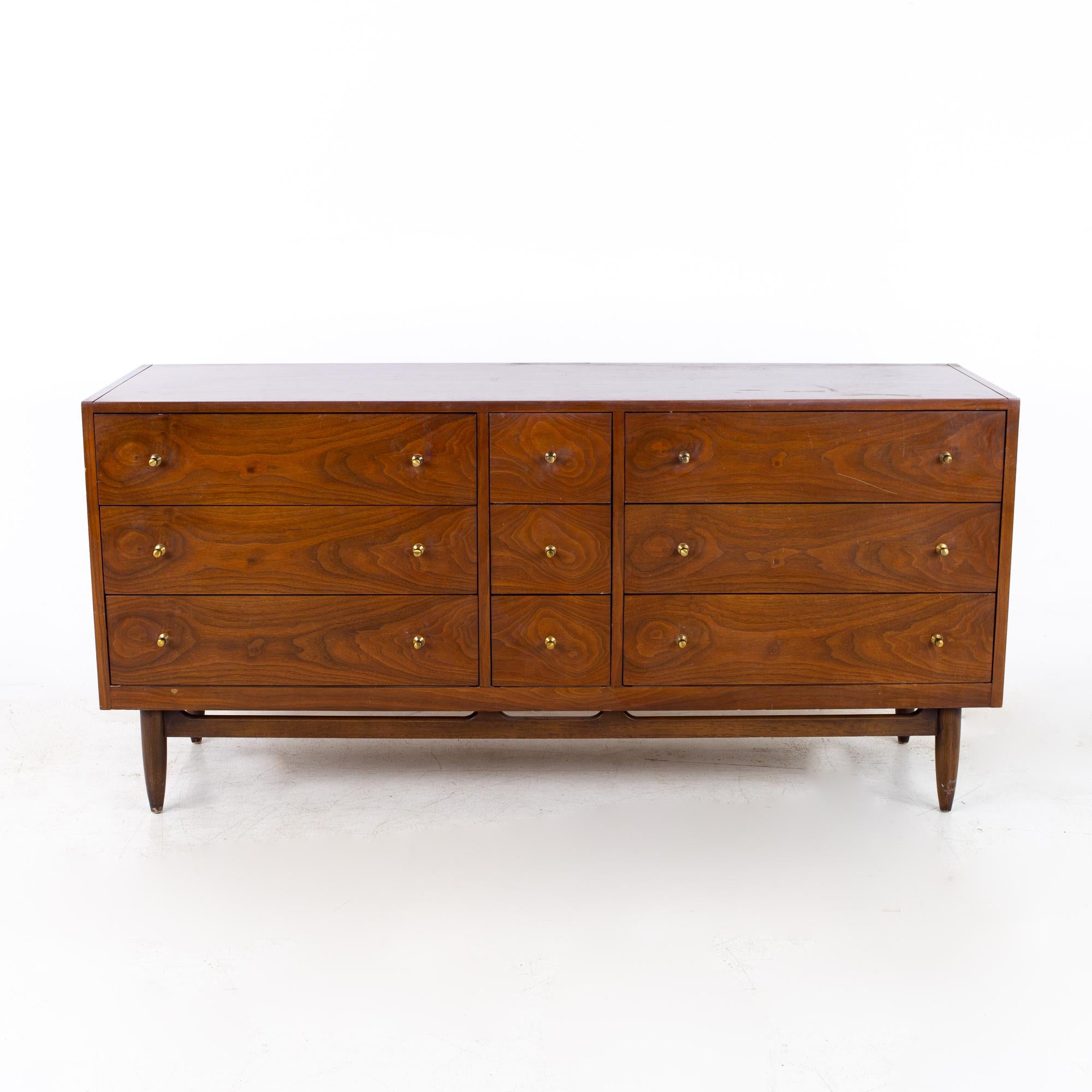 Mount Airy Mid Century Walnut and Brass 9 Drawer Lowboy Dresser

Dresser measures: 63 wide x 20 deep x 30 inches high

?All pieces of furniture can be had in what we call restored vintage condition. That means the piece is restored upon purchase so