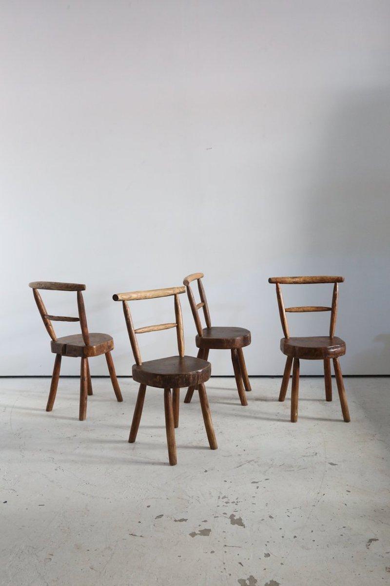 Set of ‘Arts populare’ or artisan made chairs.

Thick Elm slab seats and chunky carved branch back and legs.

French Alps 1950.
