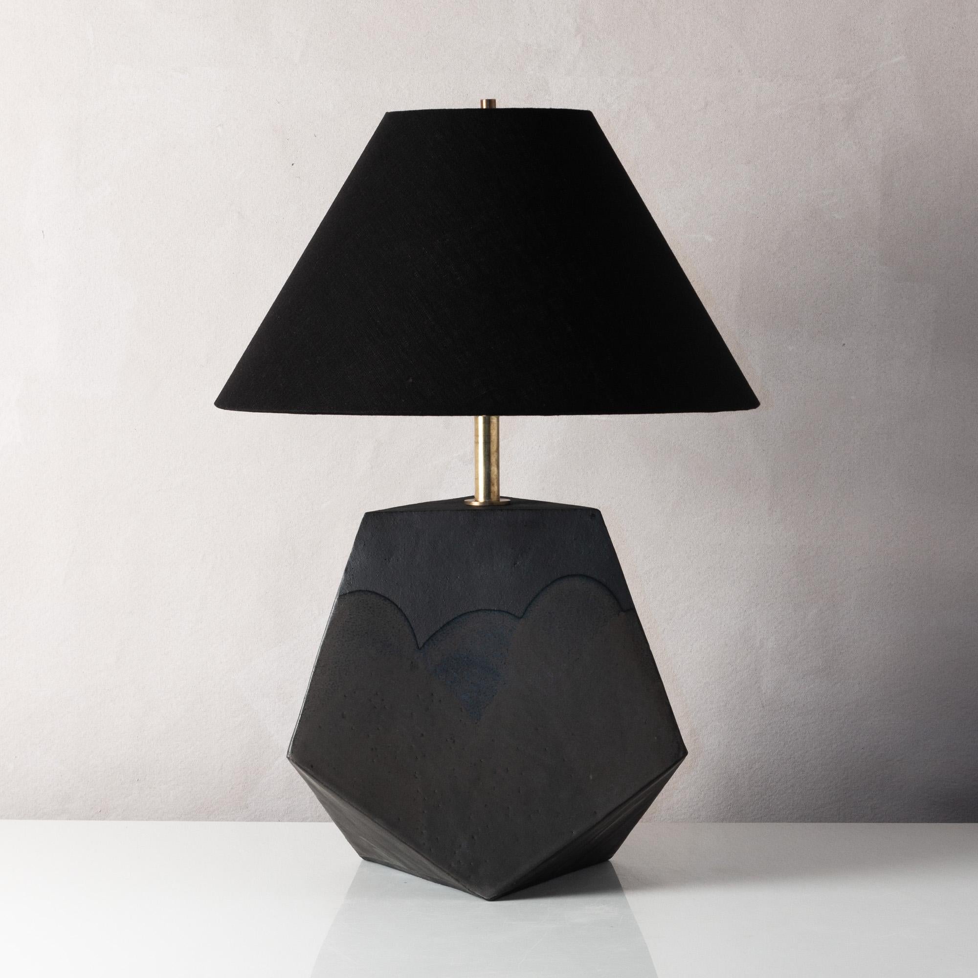 This bold geometric ceramic lamp is made from a rich red-brown clay, formed into a dramatic pyramid shape, and featuring an organic matte finish accented by hand-poured satin glaze. Each piece is individually handmade and entirely