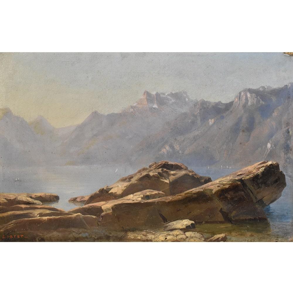 This is an antique Mountain landscape oil painting with lake, XIXth century. 19th century.
This oil painting on paper has an original gold leaf frame, original and coeval with the antique painting. 

The ancient painting is signed by a French