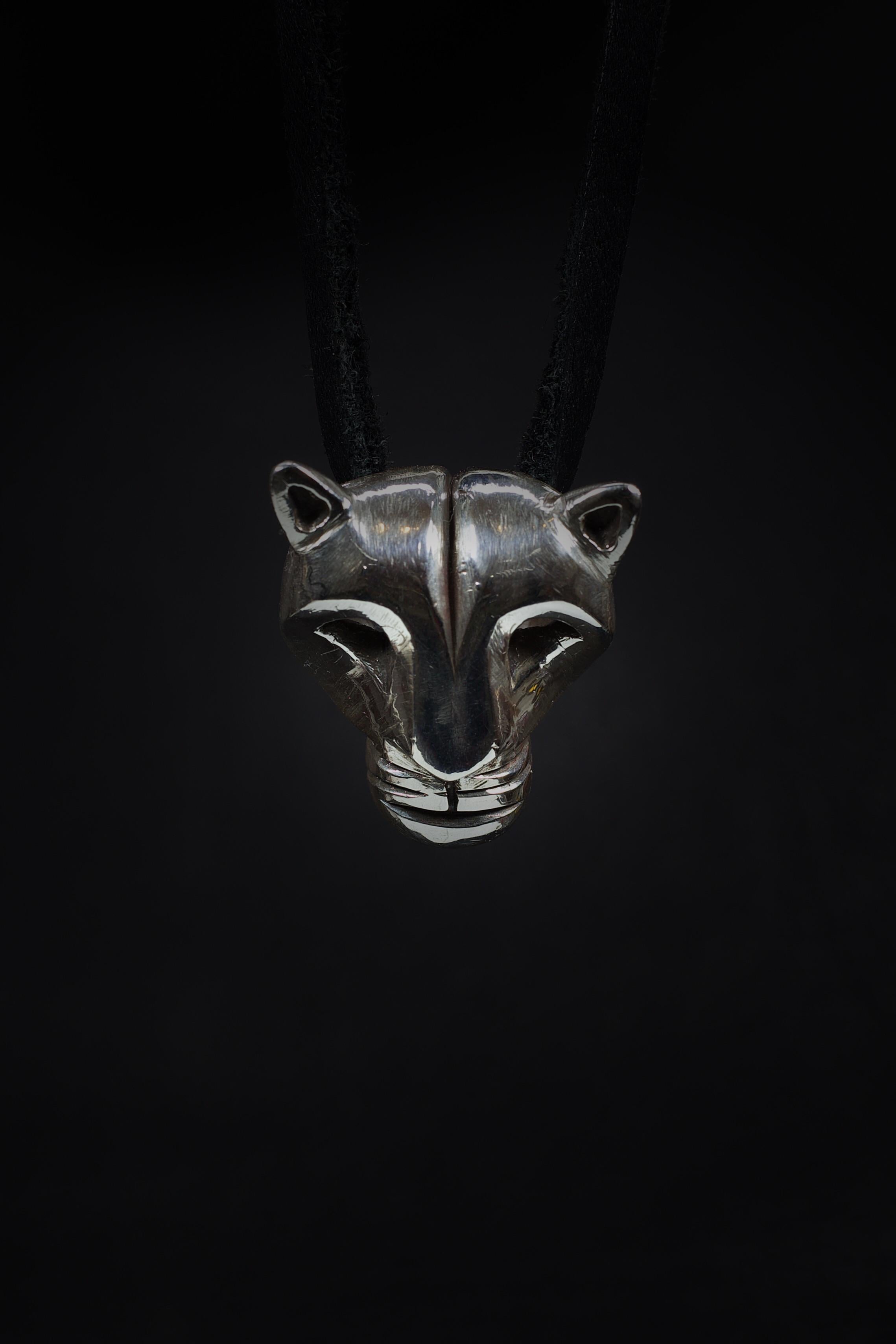 The Mountain Lion pendant by Ken Fury is a striking piece of wearable art that captures the grace and power of the elusive creature of the Southwest. Hand-carved and cast, the pendant features sharp lines and intricate details that evoke the fierce