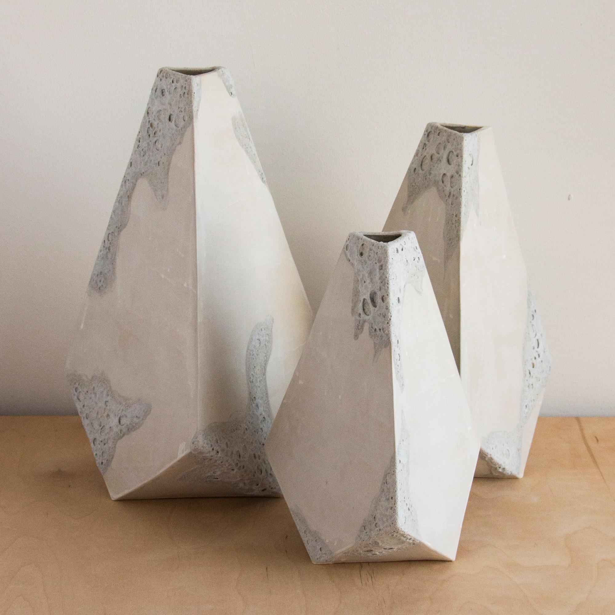 This set of 3 geometric ceramic 'Mountain' vases are made from a sandy beige clay formed into dramatic pyramid shapes. Each individually handmade piece is entirely unique, featuring an organic matte finish accented by hand painted textured white