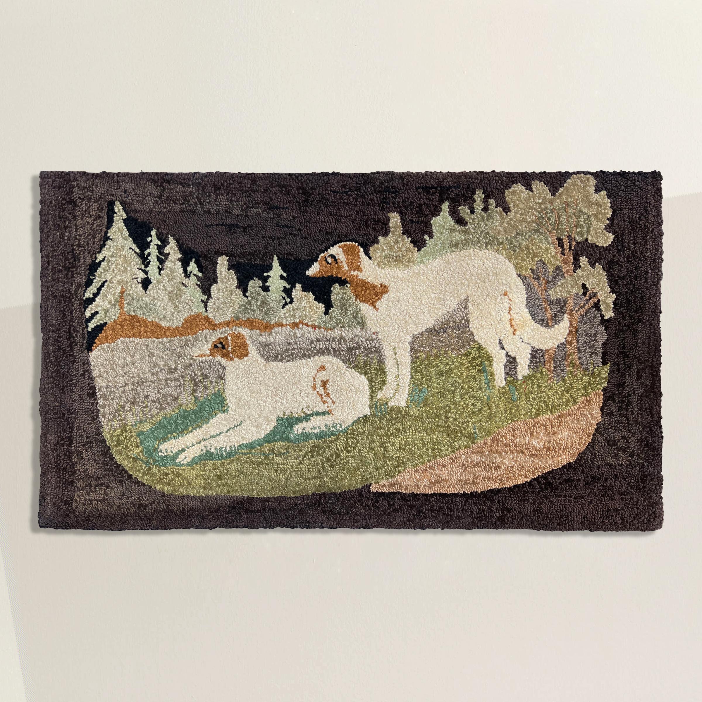 This late 19th-century American hooked rug is a captivating reflection of both its era and the rich history of the hooked rug craft in early American interior design. With meticulous artistry, it portrays two white and brown wolfhounds at rest on a