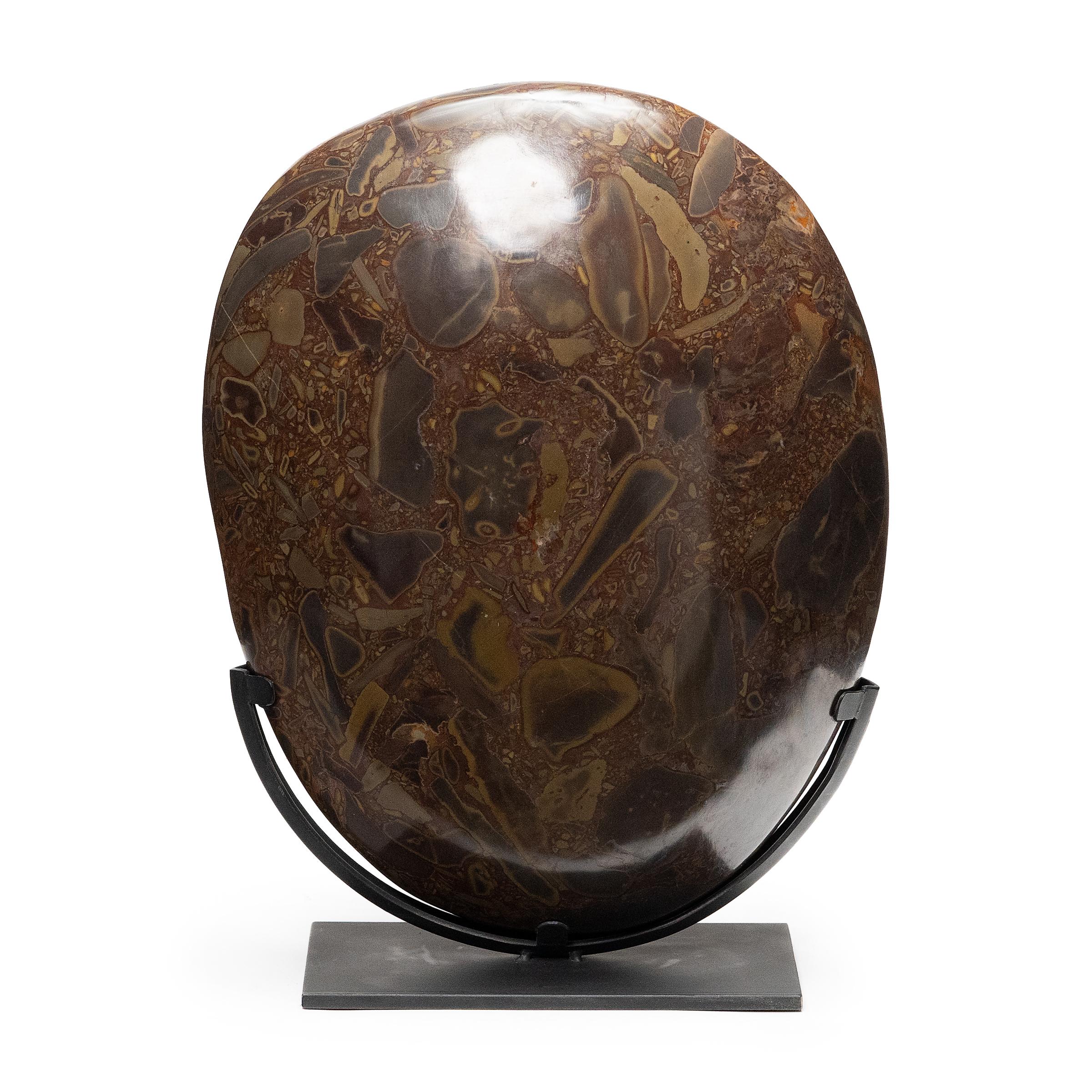 Puddingstone is named for its unique composite nature, a suspension of multicolored pebbles that resemble raisins in a pudding. Historically, the unusual stone was favored by scholar-artists and calligraphers as an ideal surface on which to place