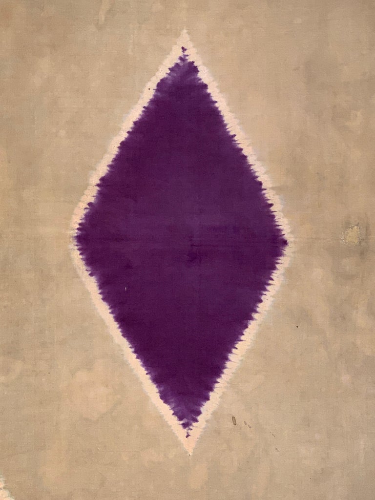 A striking Indonesian silk kain lawon with a central diamond pattern, Sumatra, Indonesia, late 19th or early 20th century. 

The ceremonial shawl, called a lawon, features a brash and bold pattern, with a central deep purple diamond surrounded by a