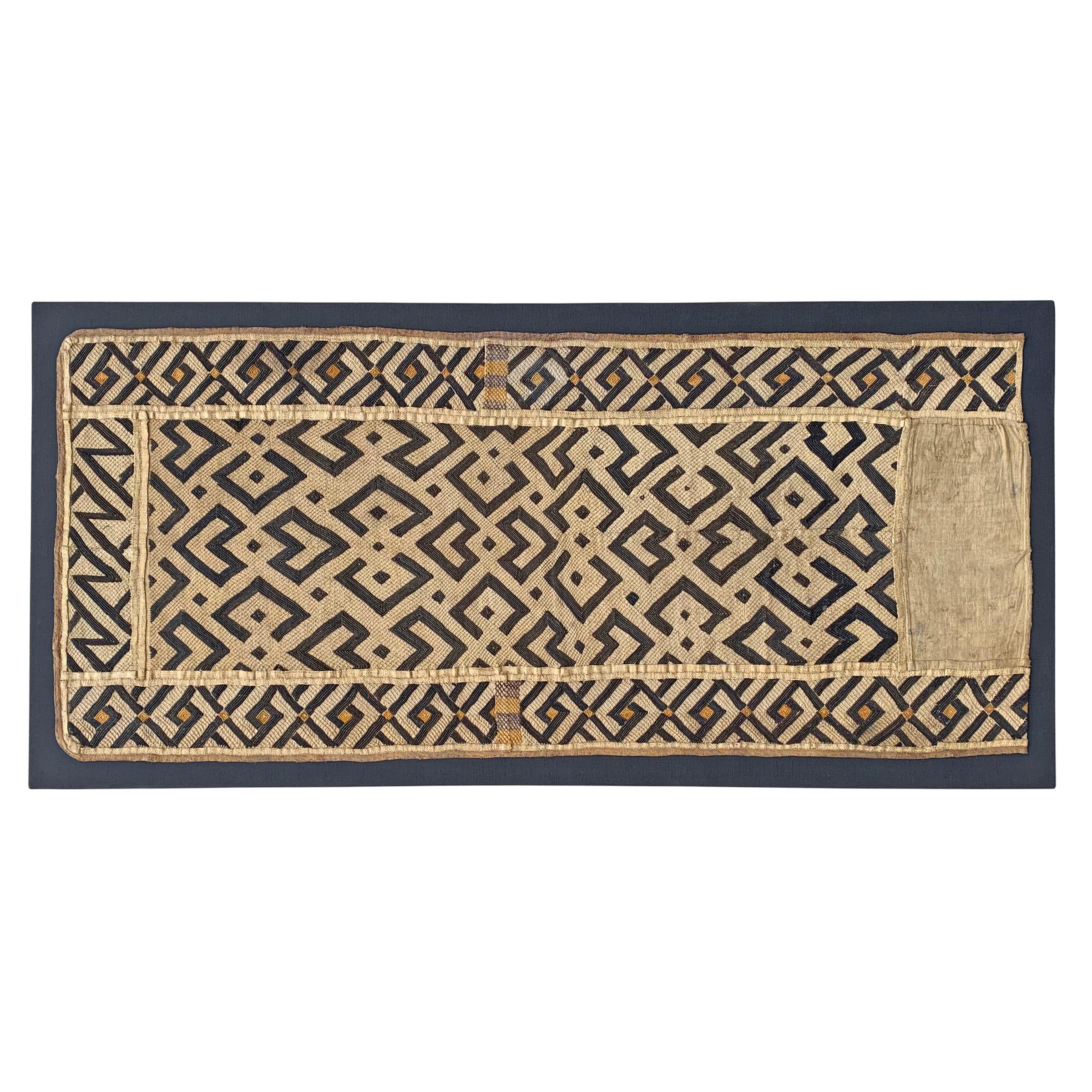 A wonderful early 20th century Kuba cloth panel with a fantastic all-over geometric pattern woven in black and natural raffia. Kuba cloths are constructed of fine strips of raffia, knotted and cut, creating beautiful geometric patterns. This piece