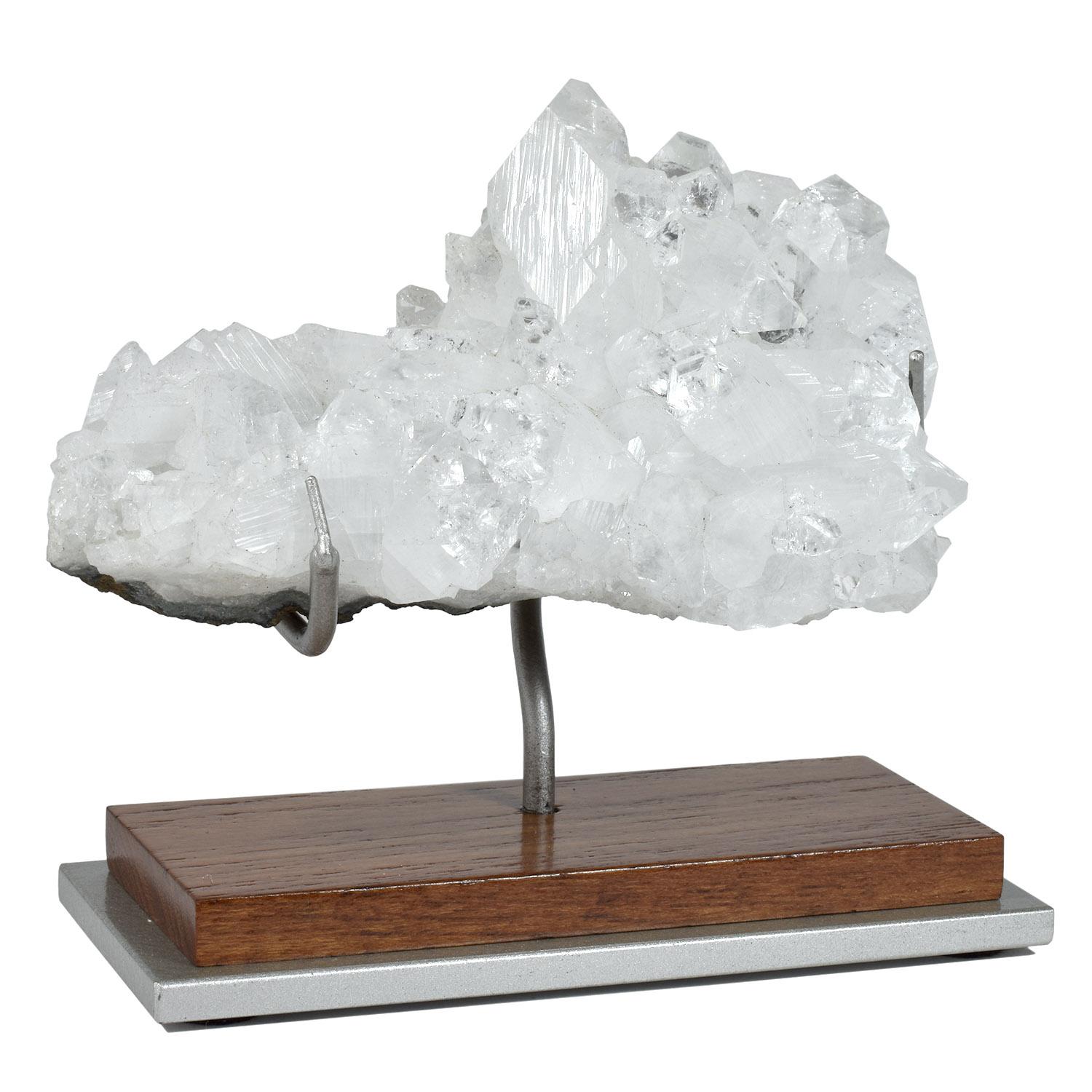 Mounted naturally-formed Indian mineral: clear apophyllite

An attractive specimen that reflects the light similarly to a multifaceted gem giving the specimen an unusual brightness. The presentation enhances the sculptural qualities and accentuates
