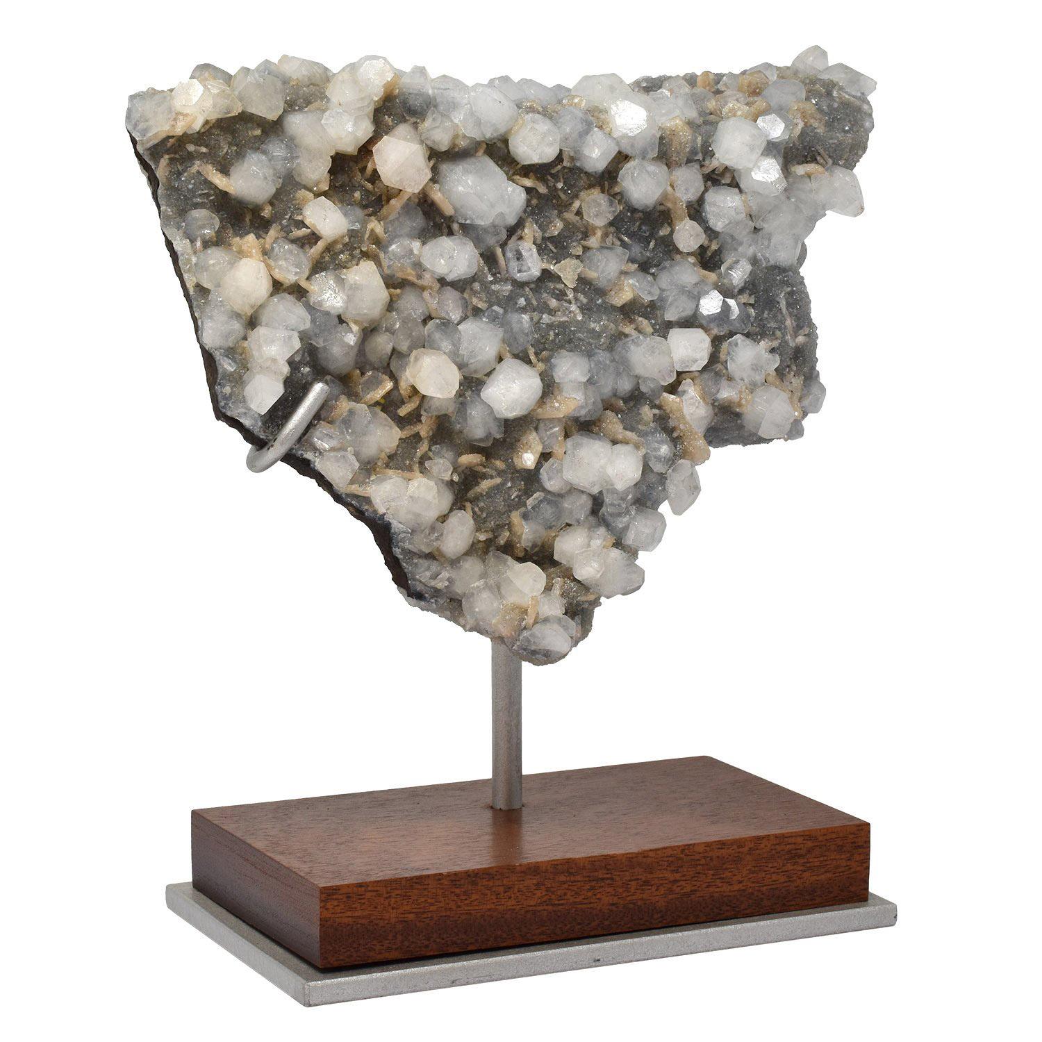 Mounted Specimen: Apophyllite, Stilbite, Chalcedony #L9W
Dimensions: 6 x 8.5 x 2.5 in. / 15 x 22 x 6 cm
Height on custom display stand: 9 in. / 23 cm

One of a kind.

The multi-faceted surfaces of the crystals create a twinkling effect as they