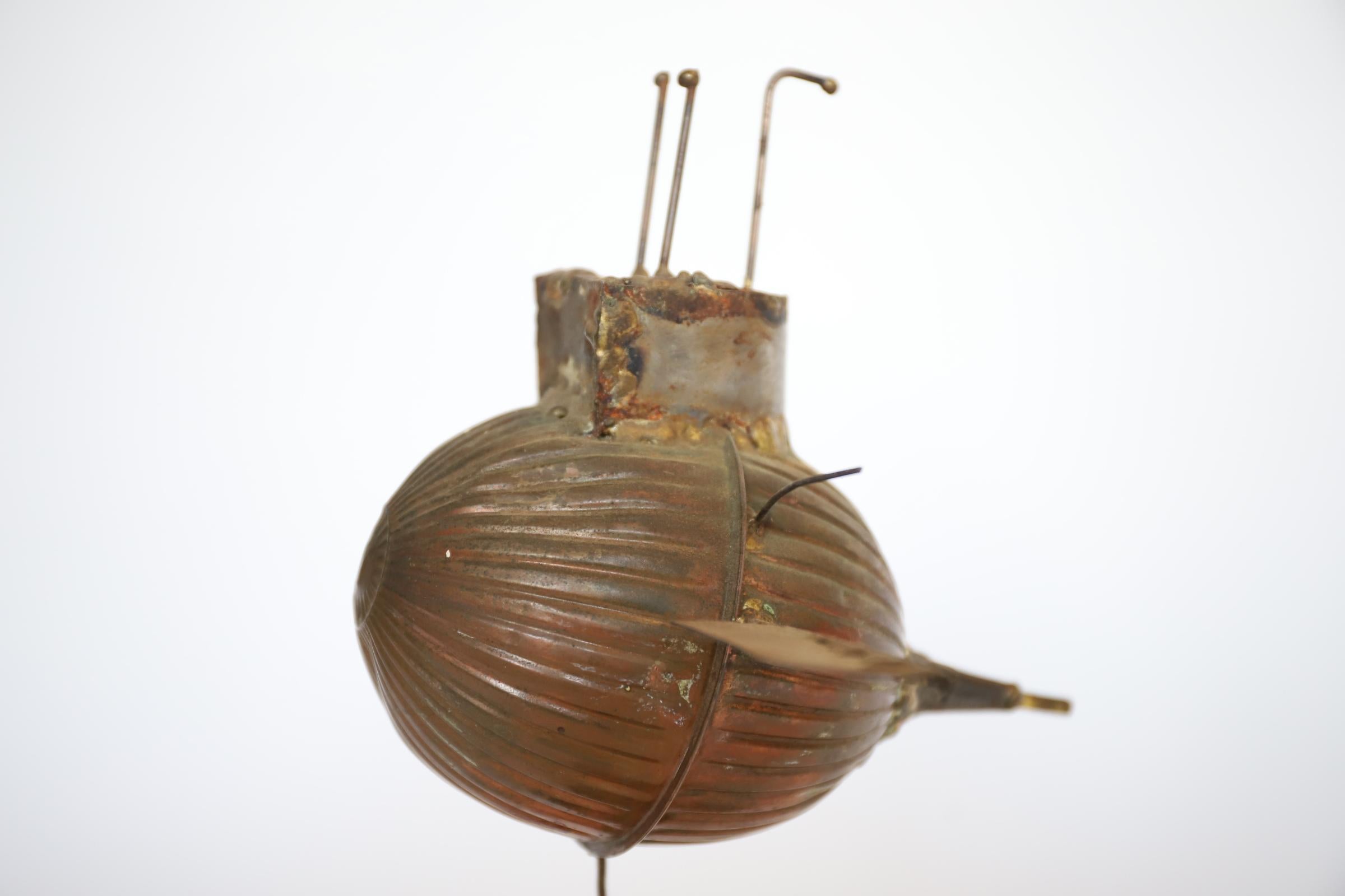 There’s trench art, and then there’s toilet humor - this is a little bit of both! Creative & fun sculpture composed of a copper toilet float, mounted on a small piece of hard driftwood. Float has a great aged patina. A bit kinetic - will sway. This