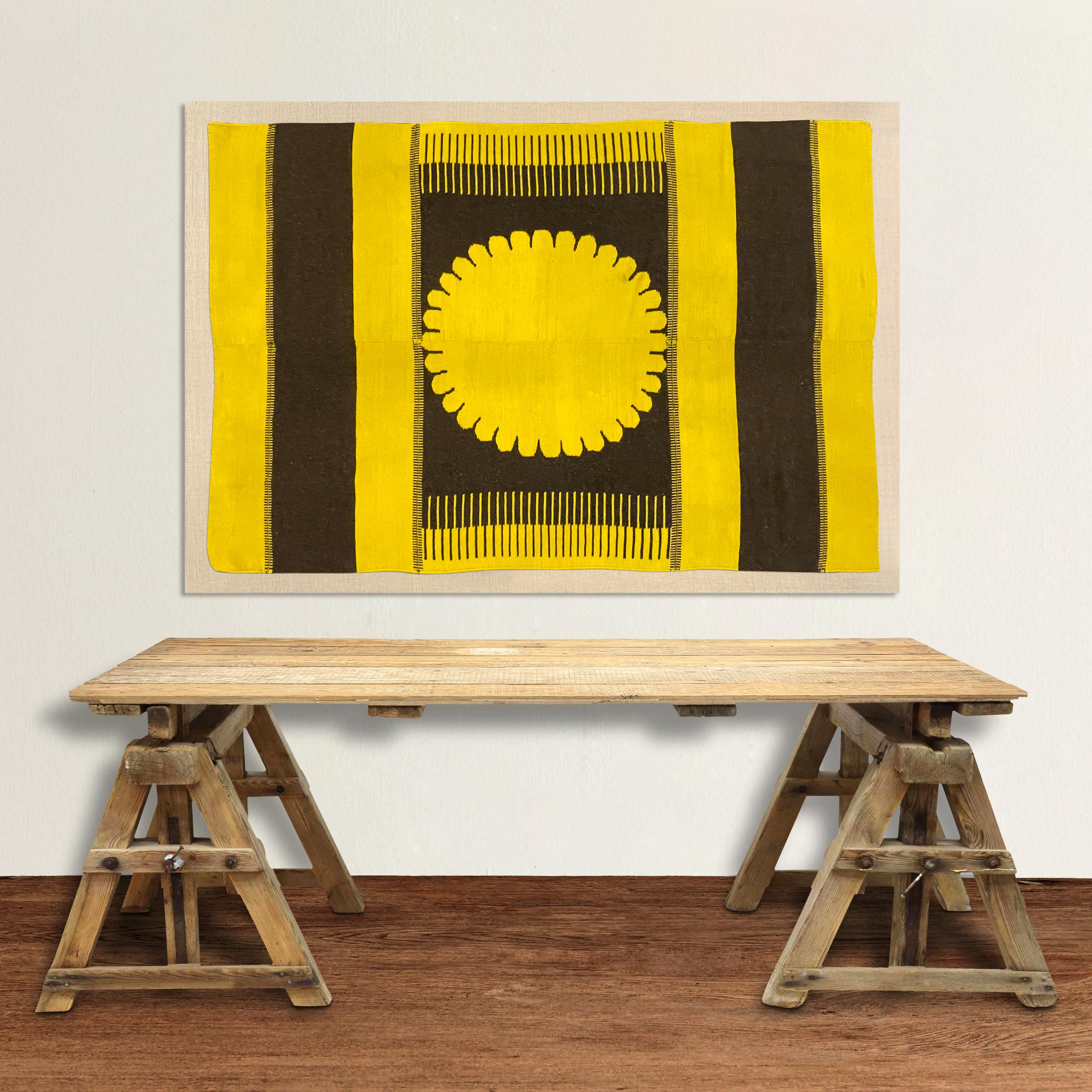 A beautiful mounted vintage Swedish wool textile with a bold large-scale golden sunburst in the center with brown and gold stripes at the ends. The textile is hand woven of two panels stitched together in the center, and mounted to a custom canvas