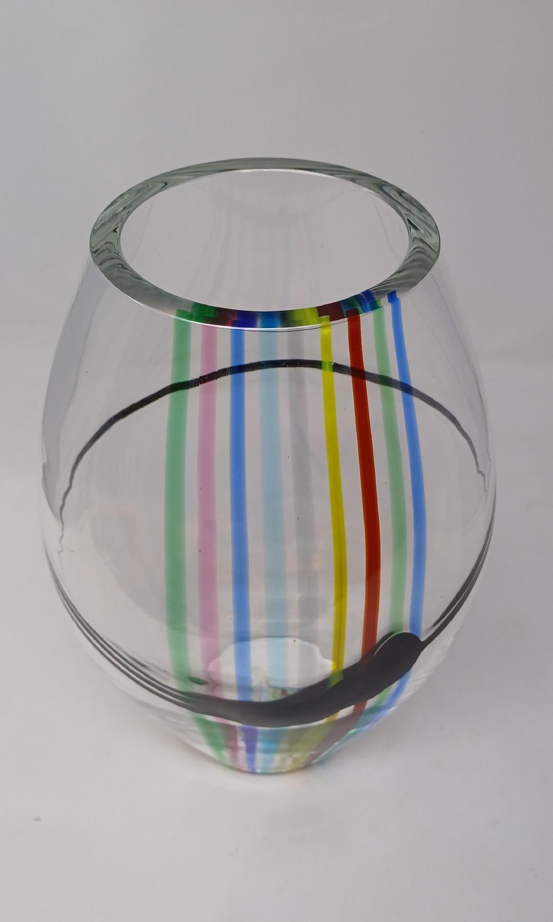 A 1970s vase with striated rainbow colors of blue, orange, pink, red, yellow and green; the thick clear glass bowl with layers of embedded colors. Created by Livio Seguso for Seguso AV.
