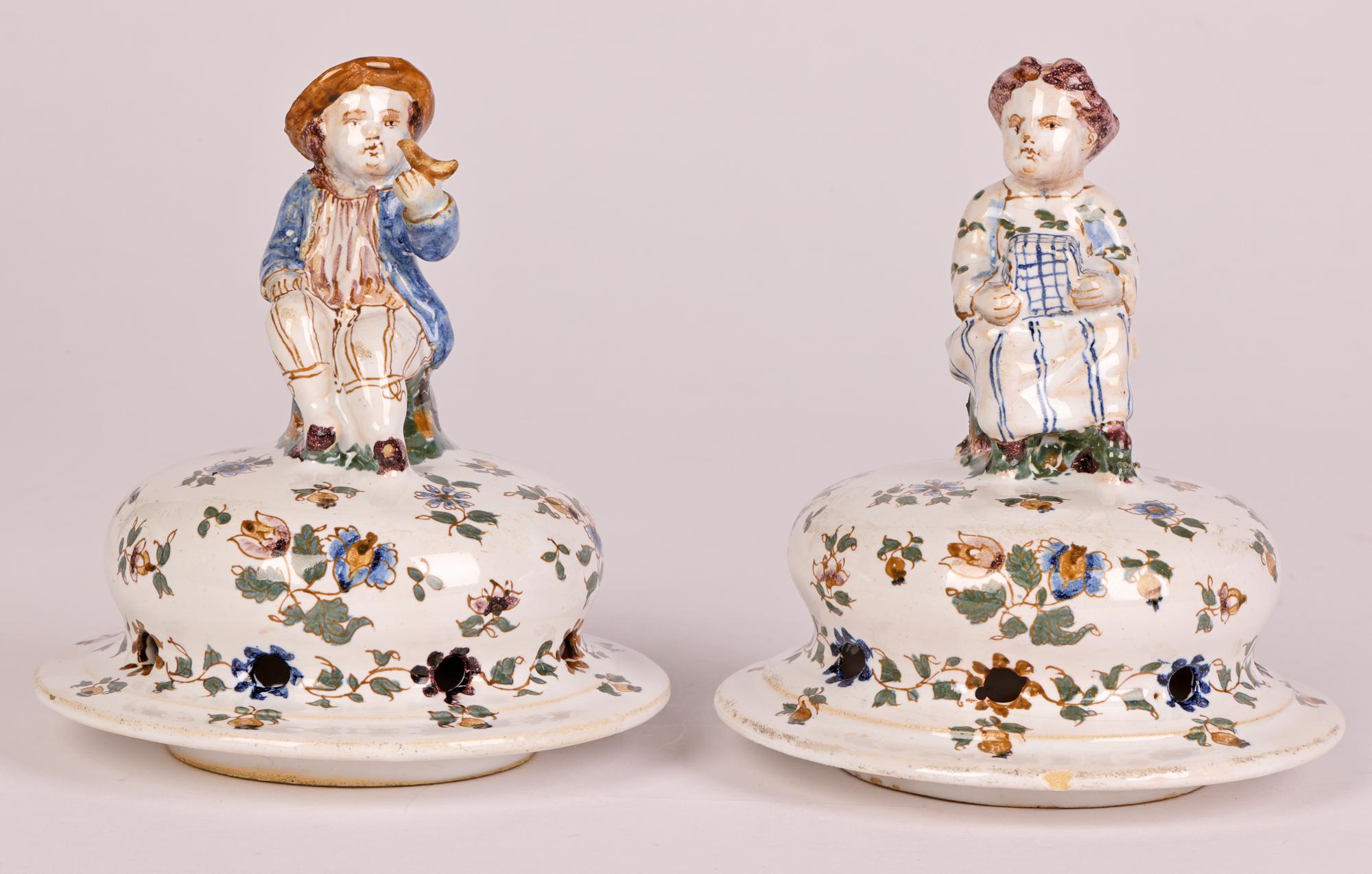 A very fine pair antique French Moustiers faience pot-pourri pottery lidded vases mounted with figures dating from the 19th century. This stunning pair of baluster shaped pedestal vases stand on a domed shape foot with narrow stem and shaped body