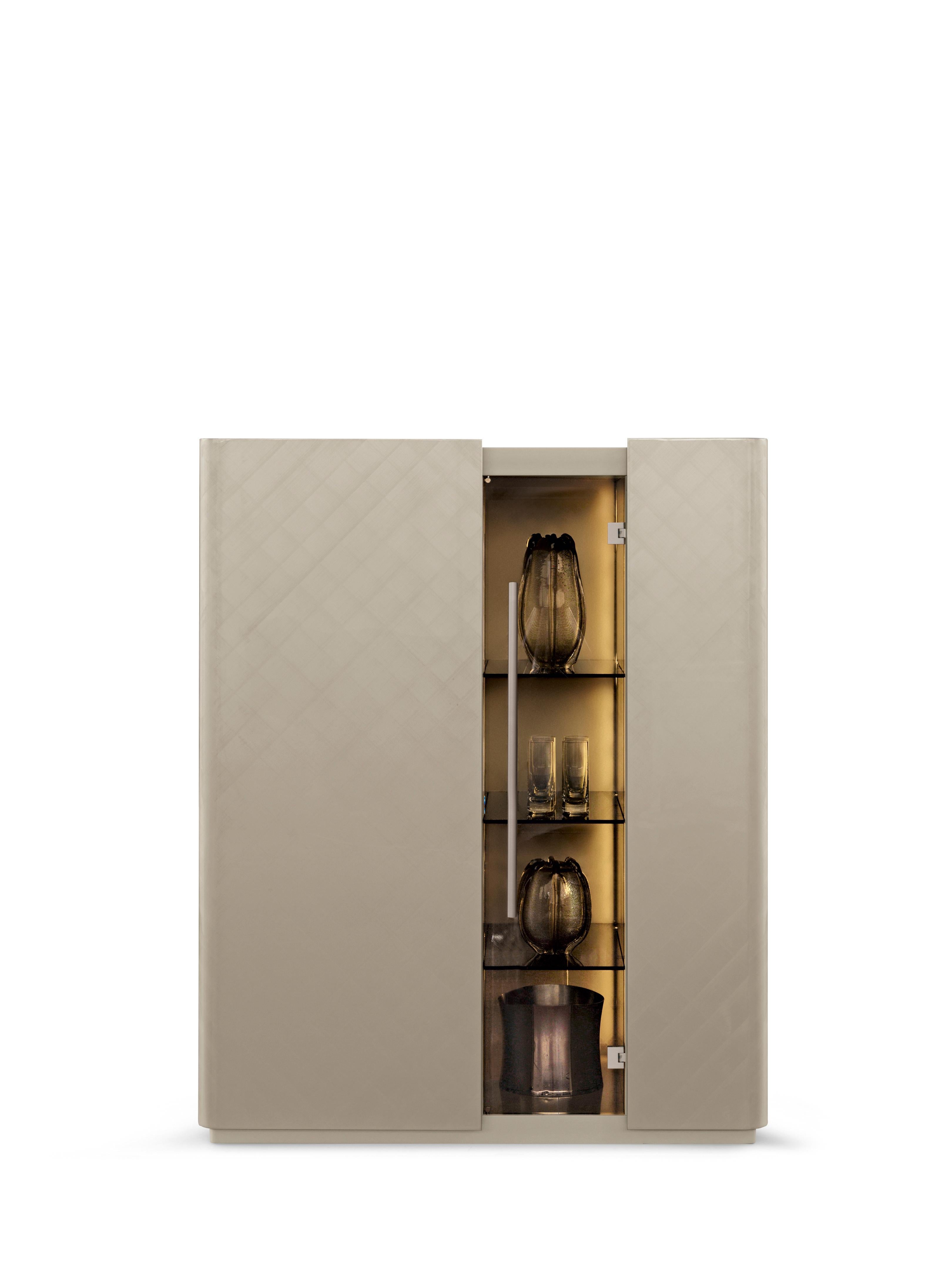 Moustique Cocktail Cabinet by Redeco
Dimensions: W 120 x D 55 x H 150 cm
Materials: Lightened mdf and mdf structure. Two outer curved doors with magnetic closing, one central bronze glass door with metal handle. Structure in Nikel lacquered