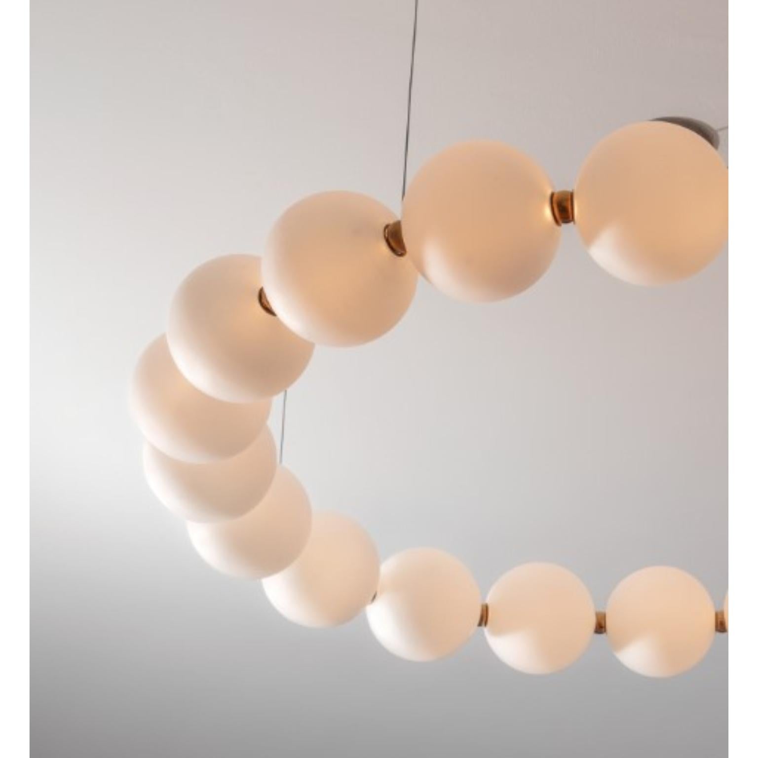 Mouth blown glass pearls round by Ludovic Clément d'Armont
Dimensions: 90 D x 12 H
Materials: Blown glass, Brass joints, Warm white LEDs

The Pearl line is a simple architectural element that helps structure a space. 
Depending on the shape you