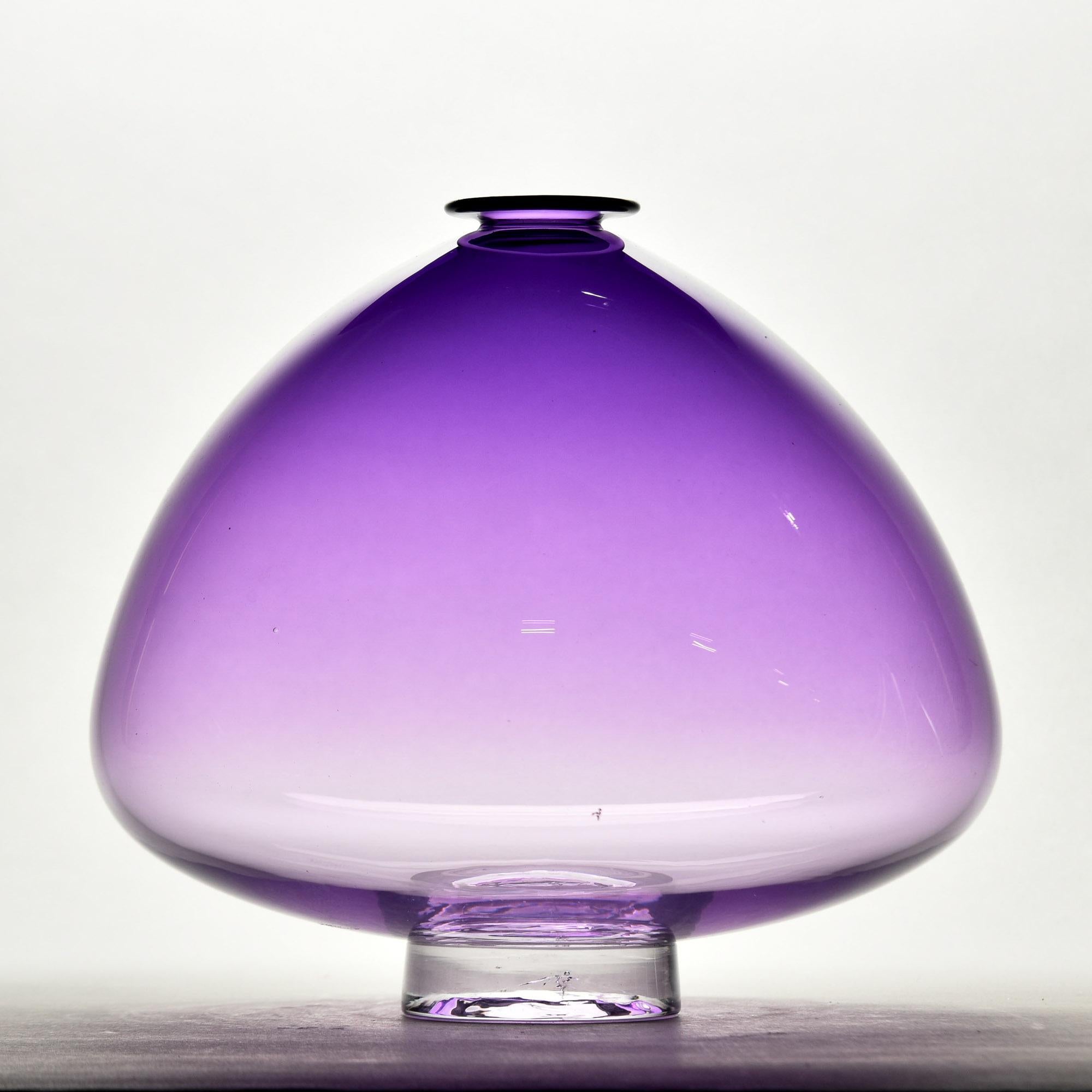 Nouveau et trouvé aux Etats-Unis, ce vase en verre d'art soufflé à la bouche présente une forme inhabituelle avec une large base et une couleur améthyste ombrée. Le vase mesure 8