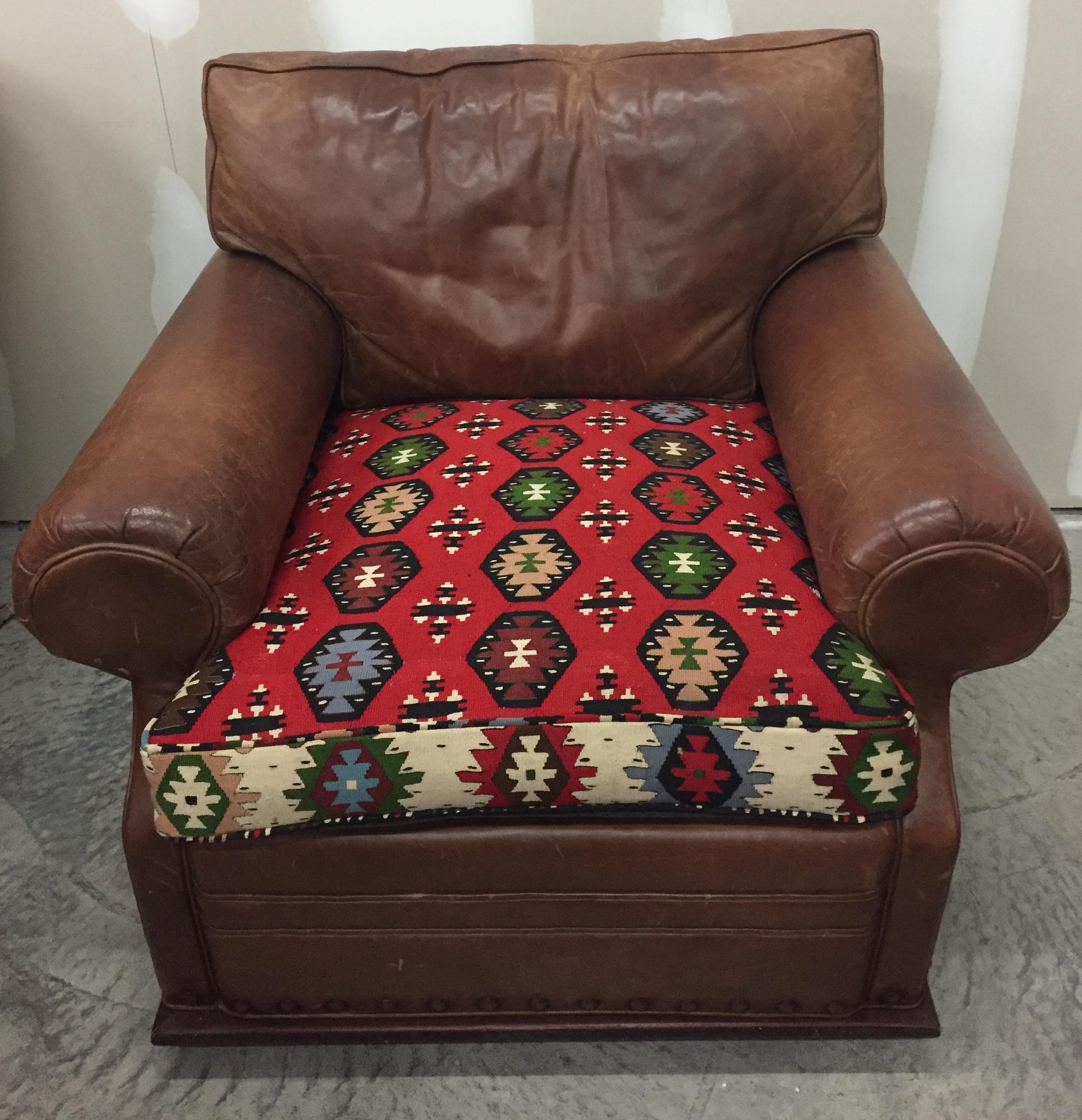 Destined to be everybody's favorite chair and ottoman set, having gorgeous distressed supple leather with rich kilim rug upholstered elements.
Measures: Ottoman 33 inches W, 25 D, 20 H.