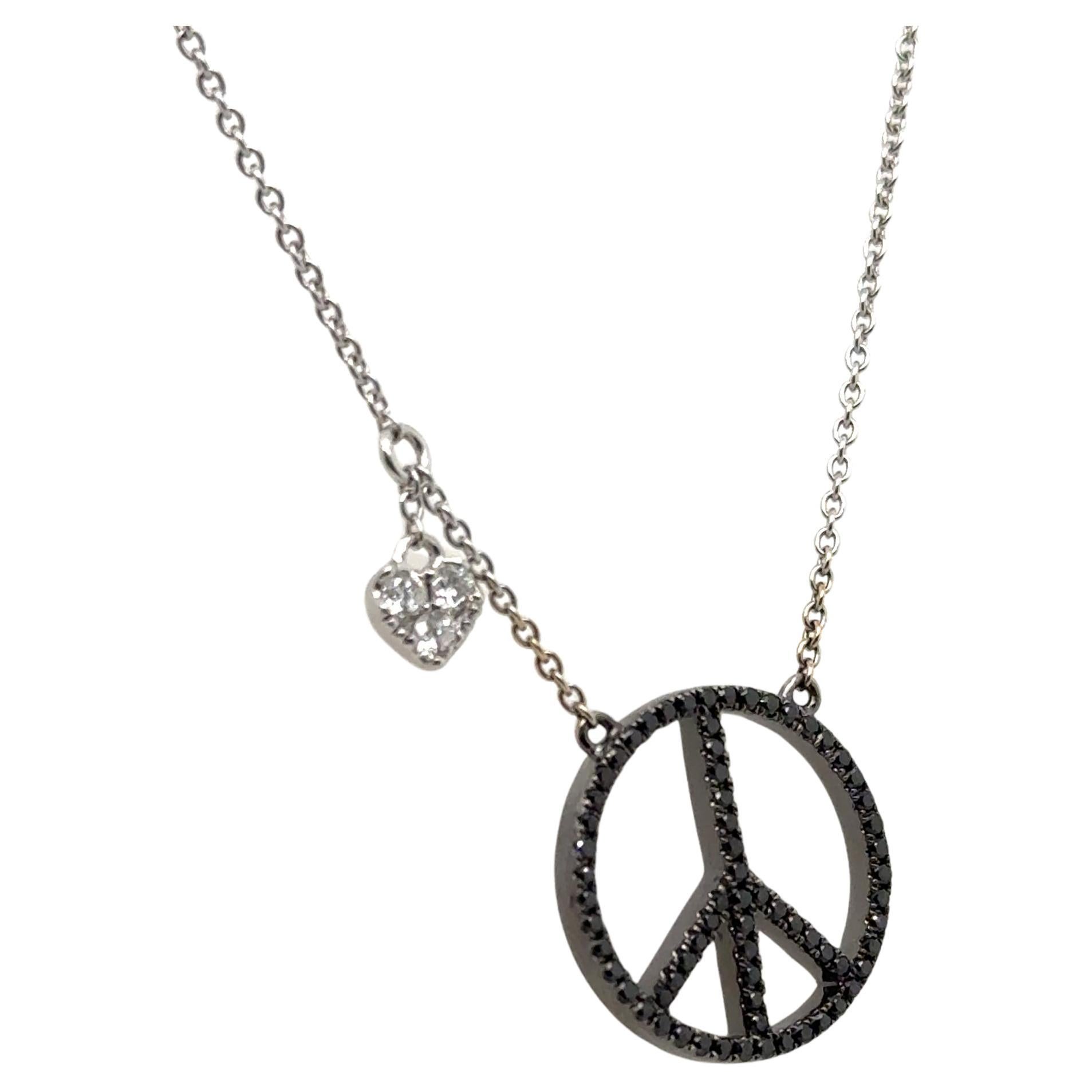 Beautiful necklace crafted by famed designer Movado.
The necklace is crafted in 18k white gold and highlights one peace sign with a heart shaped accent.
Although simple, this necklace is sure to get complimented whenever worn.
The necklace measures