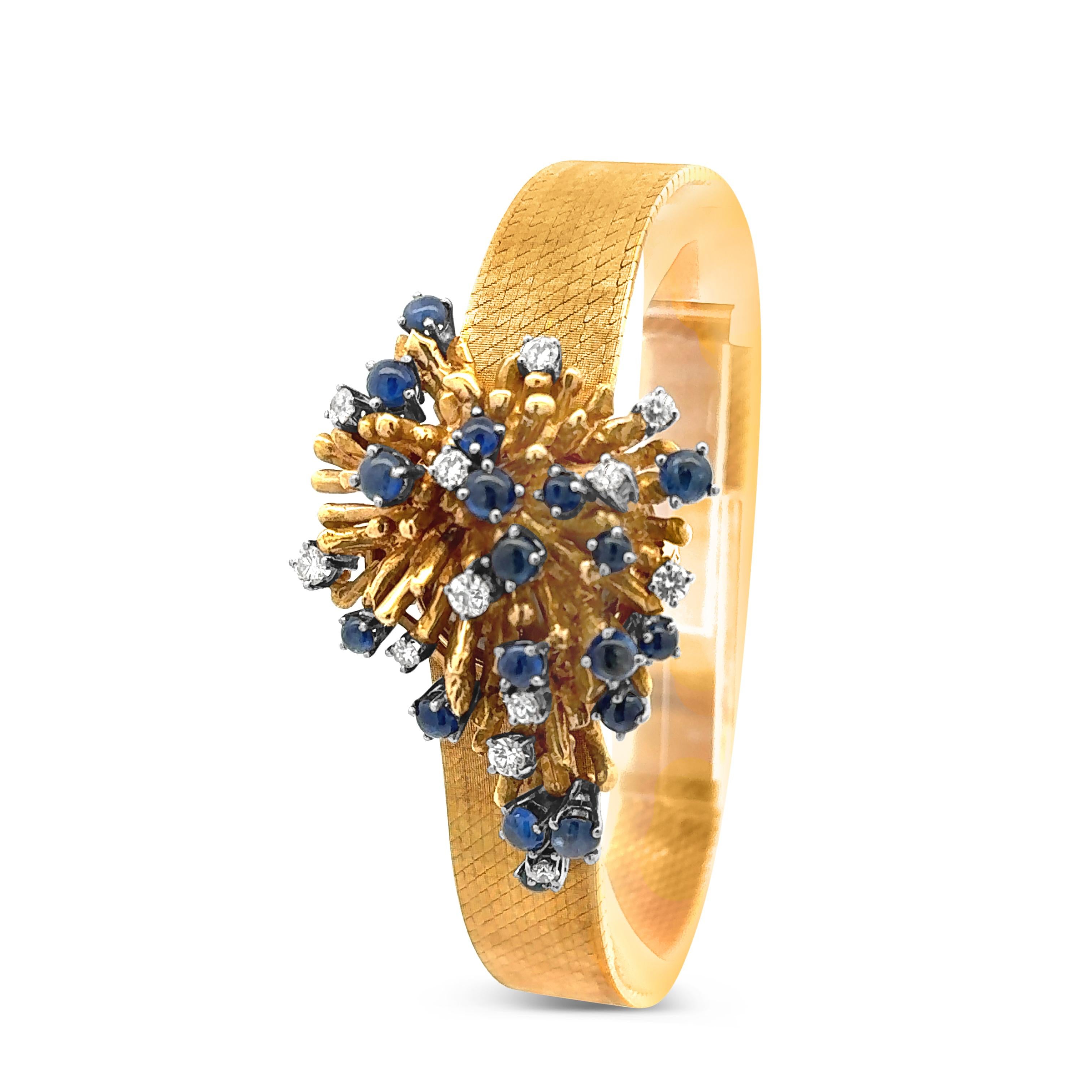A gorgeous vintage bracelet watch, featuring a watch hidden underneath a freeform burst of cabochon sapphires weighing 2.70 carats total and round brilliant cut diamonds weighing 0.85 carat total. Finely made with yellow gold, 7 inches in length.