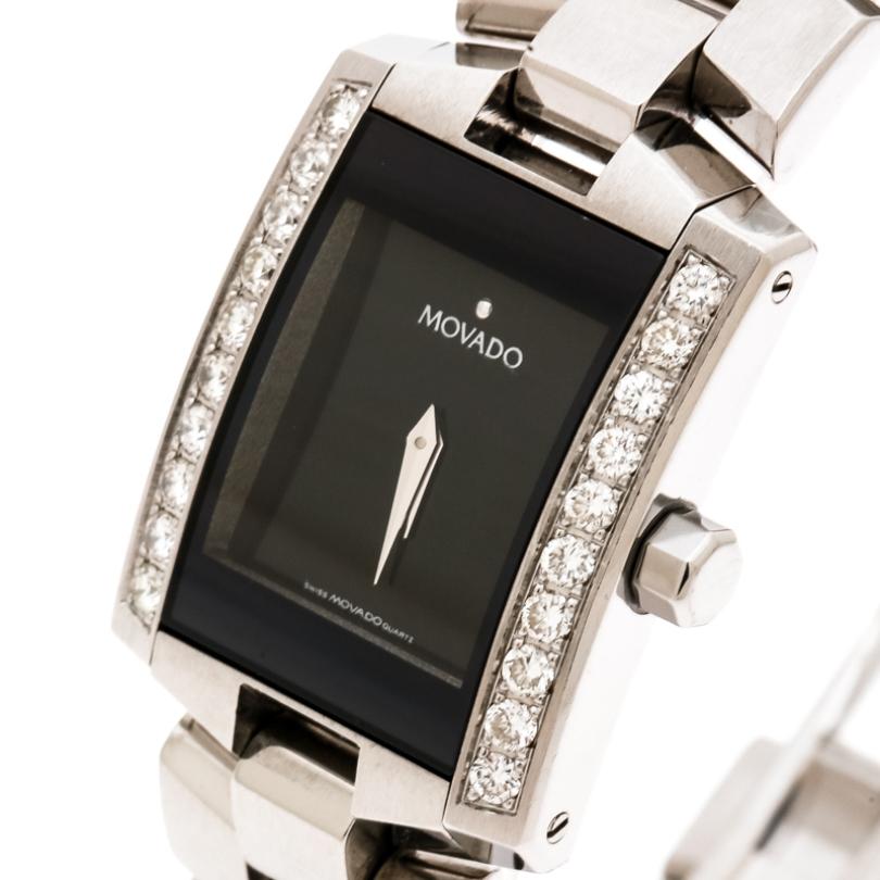 Movado leaves us awestruck with this Eliro wristwatch and makes a perfect gift for the lady of substance! This 22 mm watch, having a stainless steel dial, is accented with a beautiful diamond studded bezel. It has a black dial detailed with silver