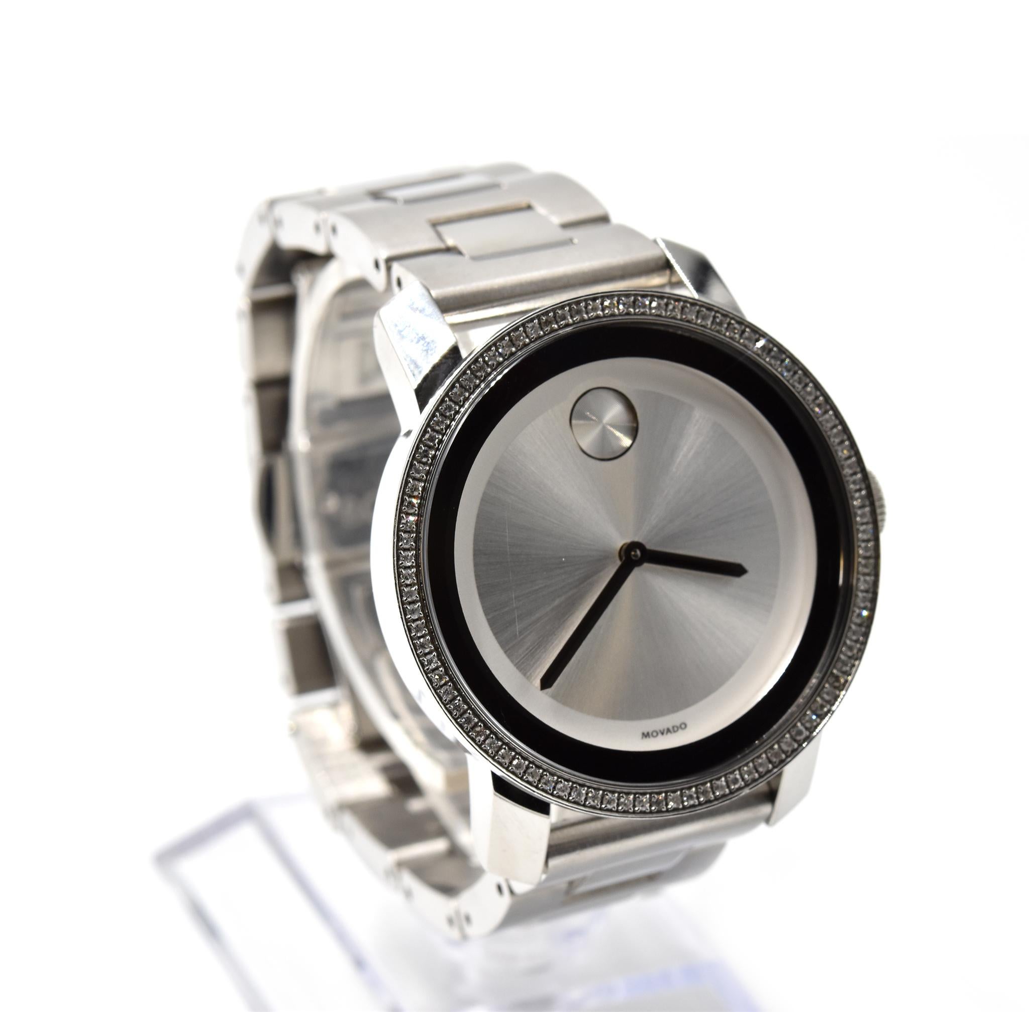 Movement: quartz
Function: hours, minutes
Case: round 36mm stainless steel case with diamond bezel, sapphire crystal, pull/push crown, waterproof to 10 meters 
Band: stainless steel bracelet with folding clasp
Dial: white dial with black