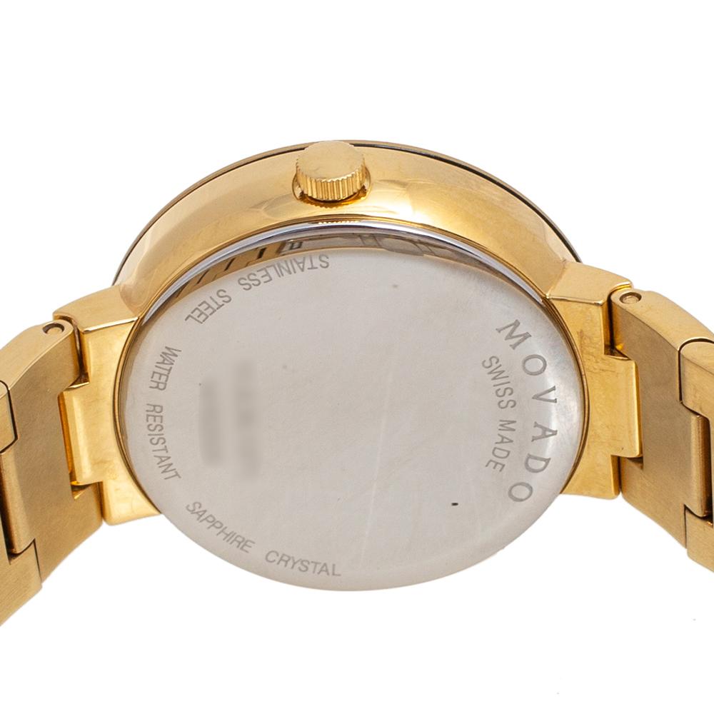 Built to assist you every day, this Movado wristwatch comes with a gold-plated stainless steel case that is held by a link bracelet. It follows a quartz movement and features a champagne mother of pearl dial with two hands and the signature dot at