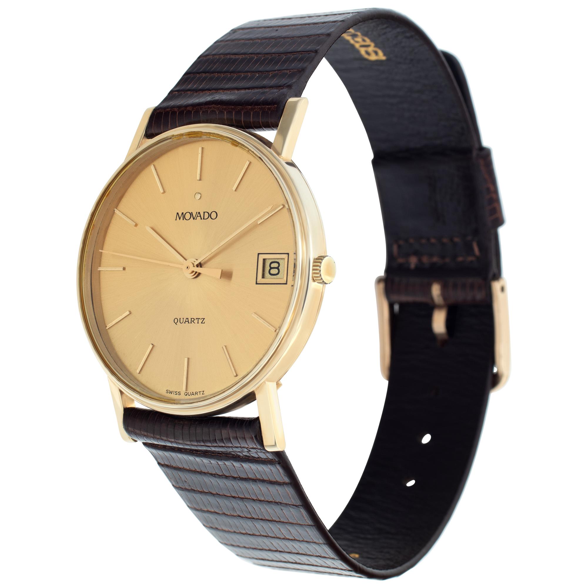Movado Classic watch in 14k on brown lizard strap. Quartz w/ sweep seconds and calendar date. 31 mm case size. Ref 51157. Circa 1960s. Fine Pre-owned Movado Watch. Certified preowned Vintage Movado Classic 51157 watch is made out of yellow gold on a