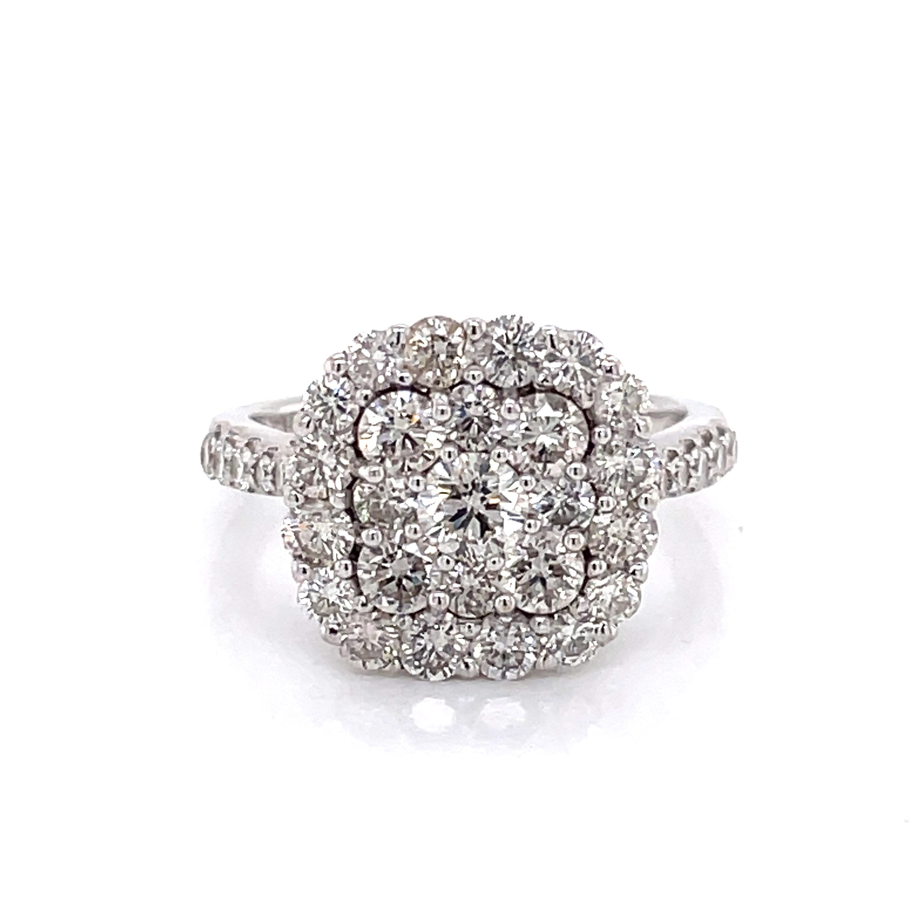 Twenty five round faceted H/VS diamonds, total weight 1.14 carats, create this flashy diamond cluster ring with halo. The square shaped ring head designed with soft corners and the clustered diamonds are individually prong set stones and create