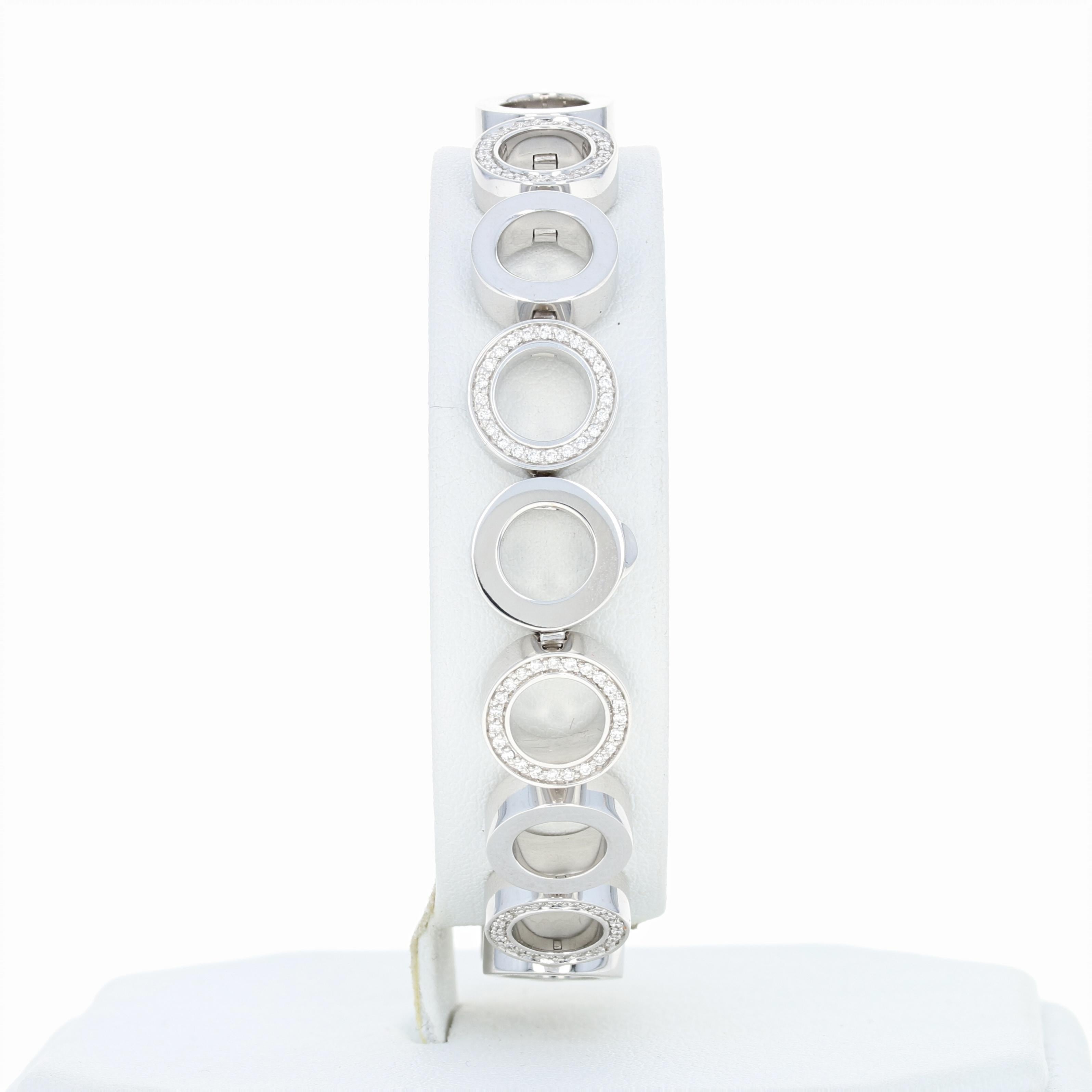 Modern elegance defined! Crafted by Movado, this luxurious 18k white gold link bracelet is fashioned in a sleek, contemporary open circle design that showcases both smoothly finished links and shimmering diamond-kissed links that are arranged in an