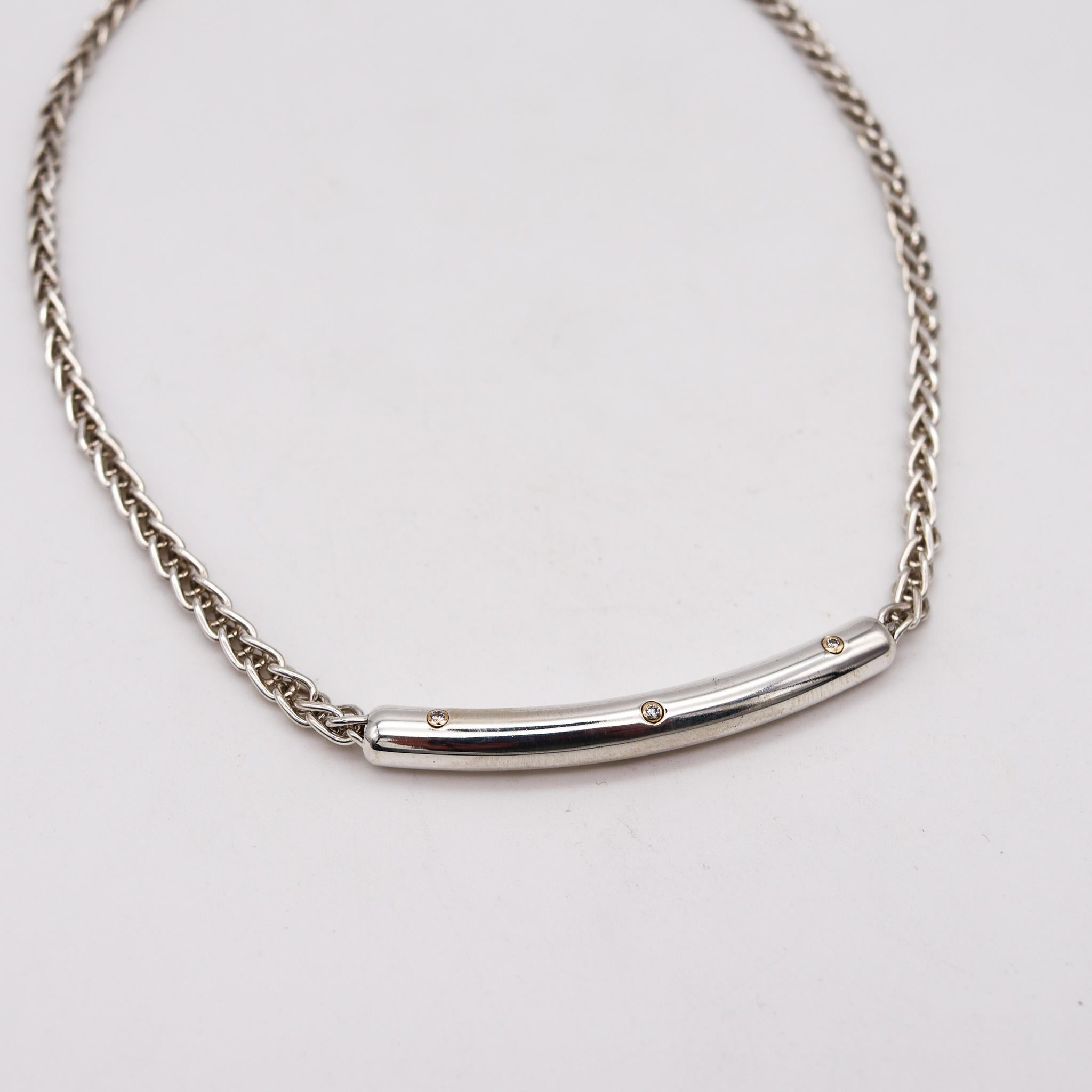 A necklace designed by Movado.

An elegant everyday piece, created by Movado in solid .925/.999 sterling silver, with accents in 18 karats yellow gold and is finished with very high polish. Fitted the center with a tubular curved element attached to
