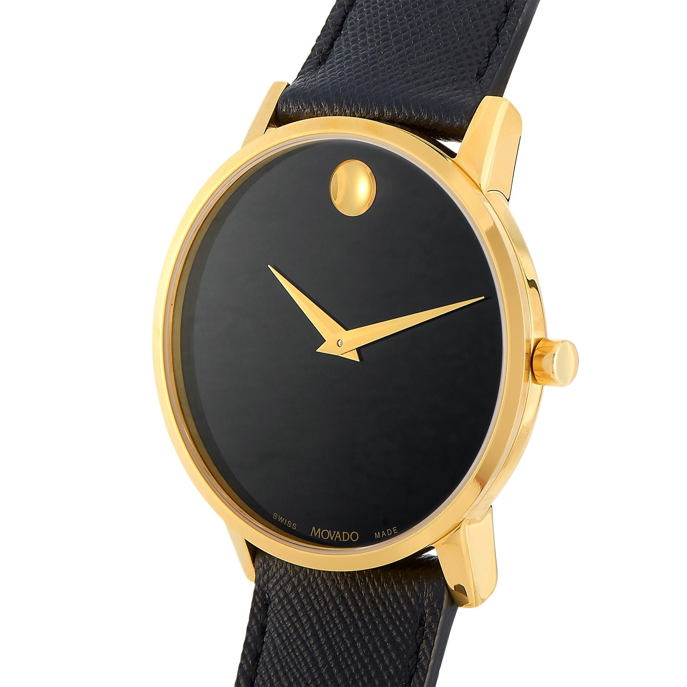 The Movado Museum Classic watch, reference number MV0607195, comes with a yellow PVD-plated stainless steel case that measures 40 mm in diameter. The case is presented on a black saffiano leather strap, secured on the wrist with a tang buckle. This