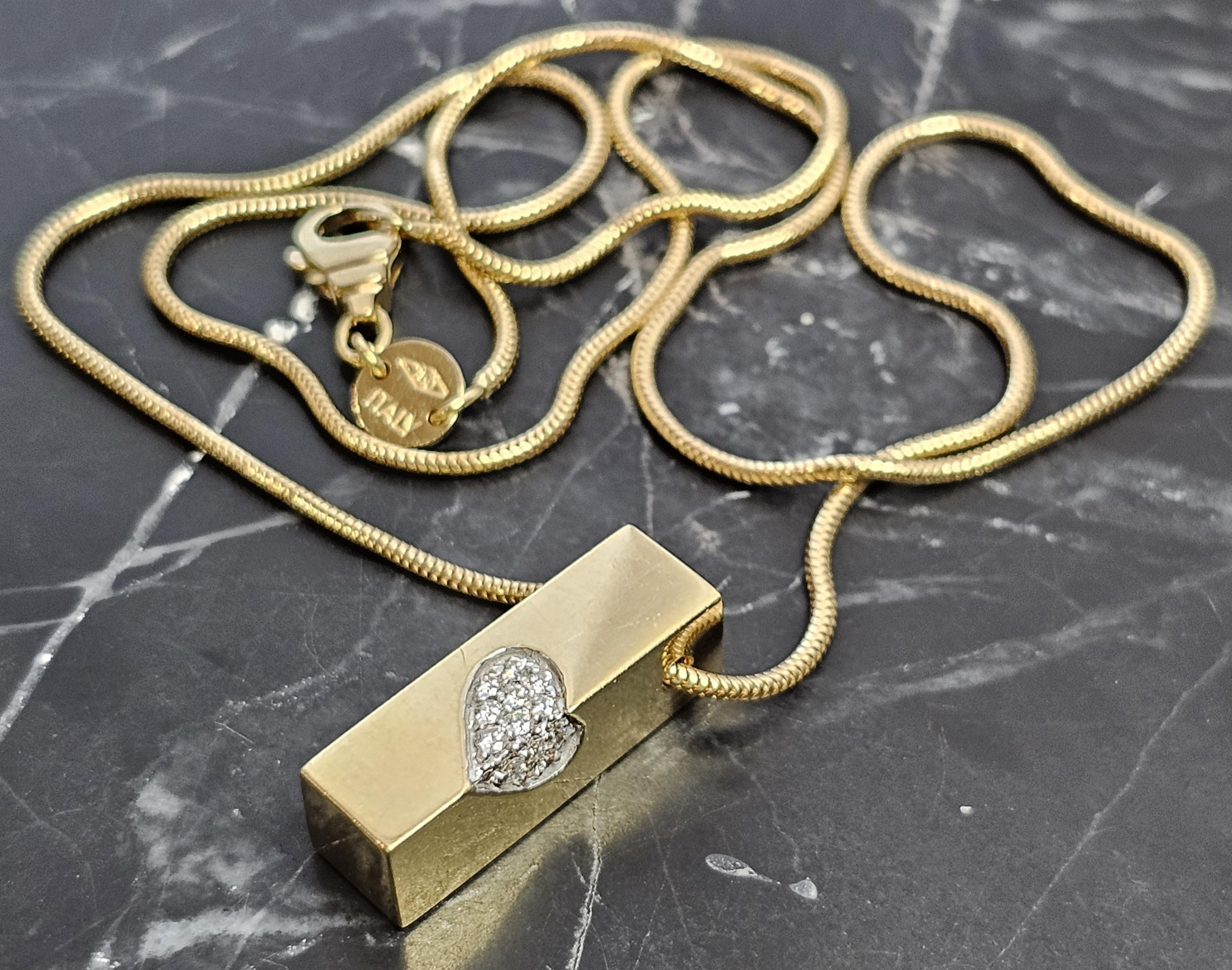 Elevate your style with this stunning Movado pendant necklace. Crafted from 18k yellow gold, this piece features a rectangular pendant adorned with a heart-shaped design, encrusted with round white diamonds. The pendant hangs elegantly from a sleek