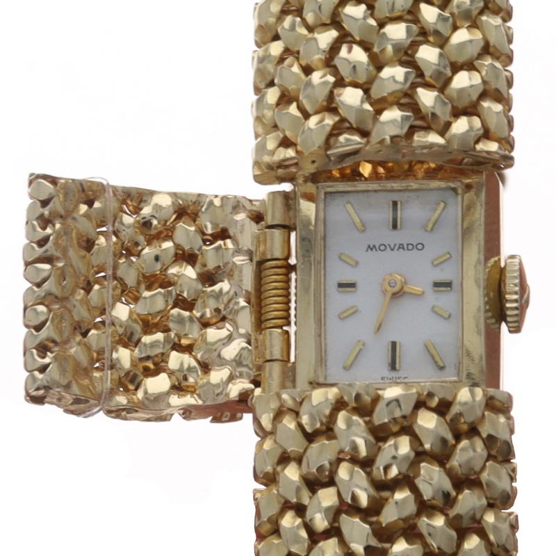 Marke: Movado
Bewegung: Manuell
Anzahl der Juwelen: 17
Garantie: Ein Jahr
Jahr: 1950er Jahre
Uhrwerk-Hersteller: Schweiz
Zifferblattfarbe: Silber

Metallgehalt: 14k Gelbgold

Stil: Geheime Armbanduhr
Verschluss-Typ: Tab Box Clasp mit einseitiger