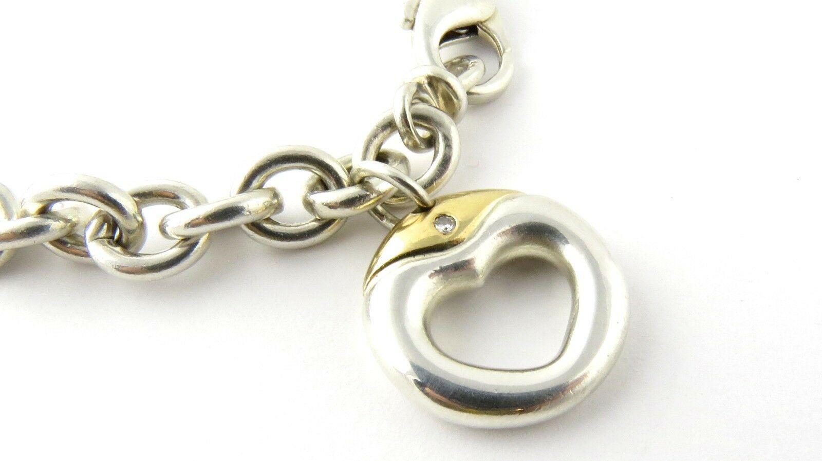 Movado Sterling Silver and 18K Yellow Gold Diamond Heart Link Charm Bracelet

This authentic Movado charm bracelet is approx. 7.75