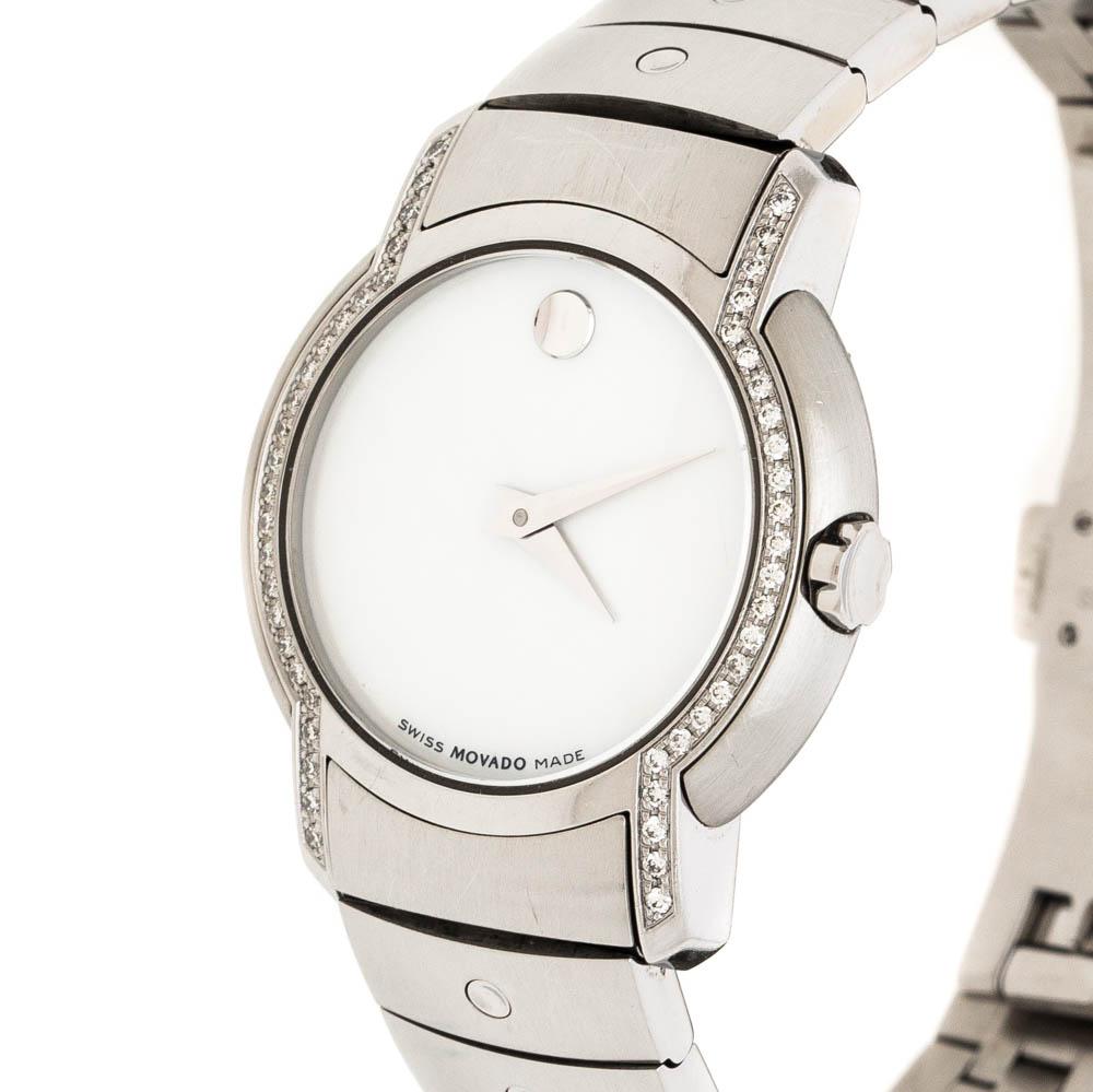 Built to assist you every day, this Movado wristwatch comes crafted from stainless steel and is adorned with diamonds on the bezel and lugs. It follows a quartz movement and features a plain white mother of pearl dial with two hands and the