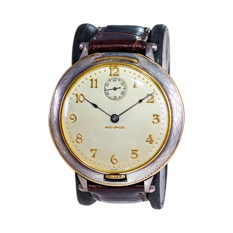 FACTORY / HOUSE: Movado Watch Company
STYLE / REFERENCE: Pocket Wrist Watch / Ref. 27850
METAL / MATERIAL: Sterling Silver / 14Kt. Yellow Gold Trim
DIMENSIONS: Length 52mm  X Diameter 48mm
CIRCA: 1930's
MOVEMENT / CALIBER: Manual Winding / 15 Jewels