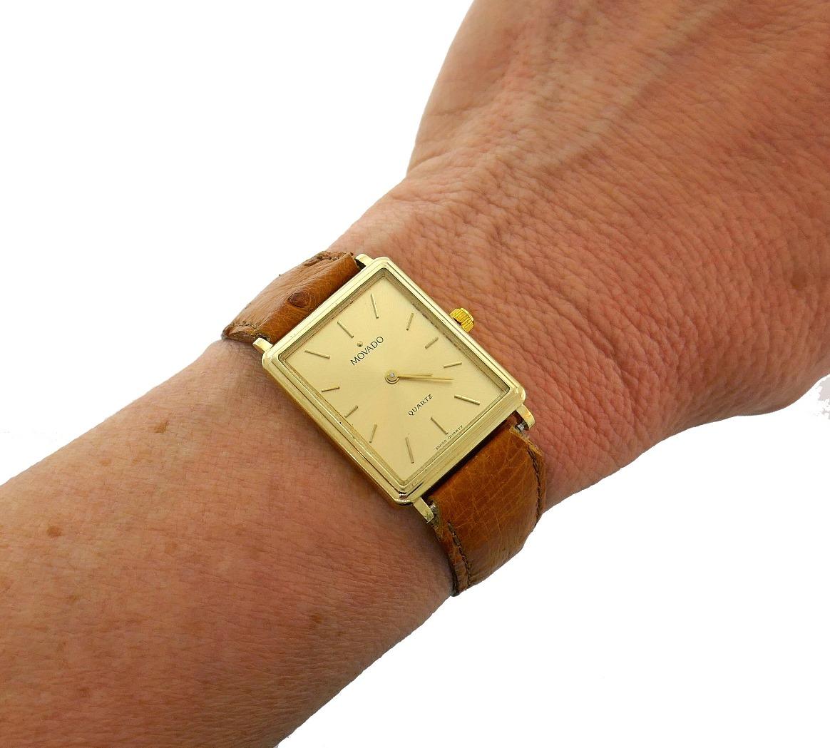 Classy and timeless unisex watch created by Movado in the 1980s. 
The watch is made of 14 karat (stamped) yellow gold, the tan color strap is handmade of genuine ostrich leather.
Measurements: 1-1/8 x 15/16 inches (28 x 24 mm). 
The watch is Swiss