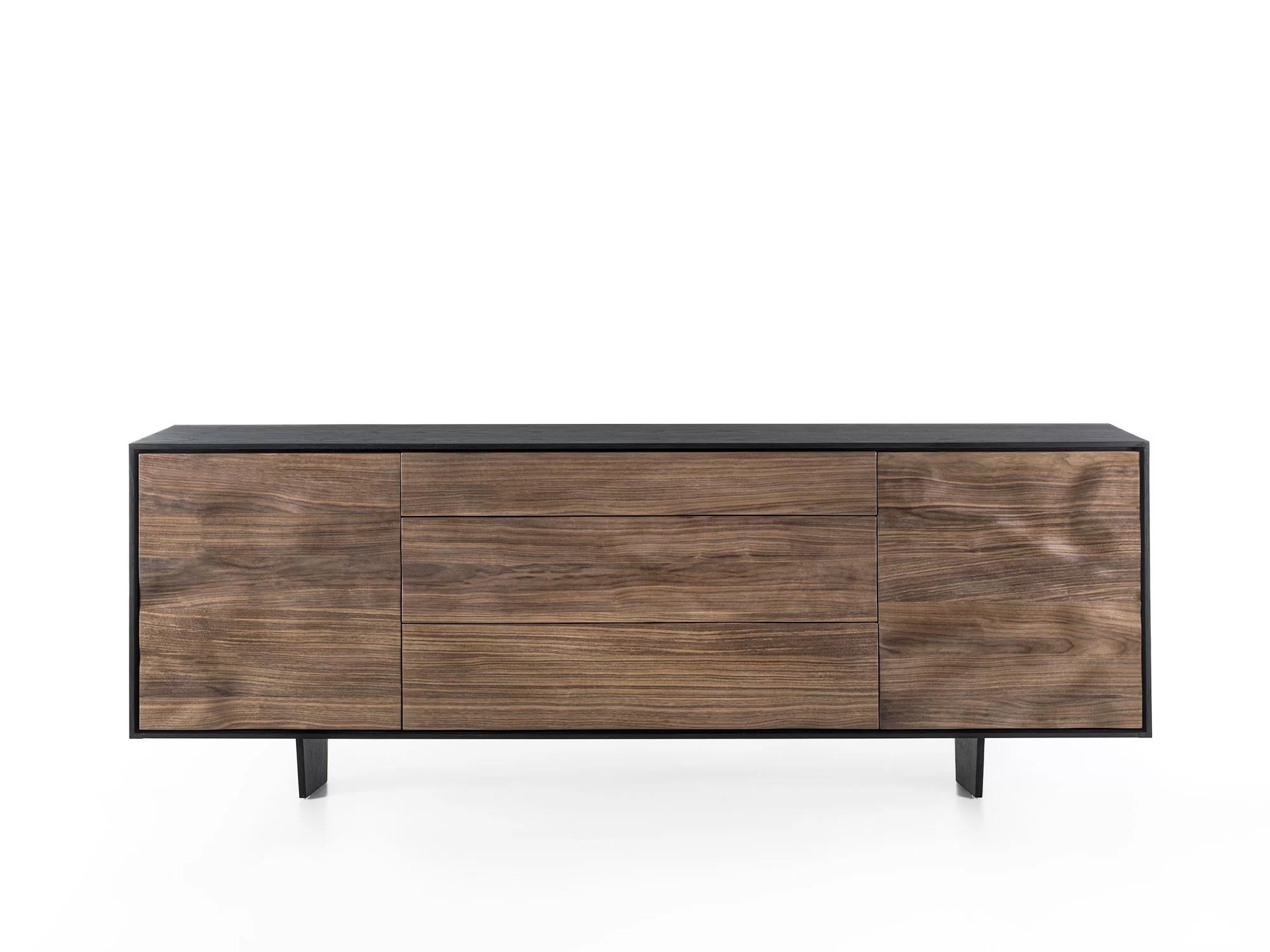 Solid wood and blockboard sideboard with a wooden frame. The unique processing technique applied to the doors and the front of the drawers creates a sculptural effect through the extroflection of the wood, endowing it with a sinuous movement. 

Made