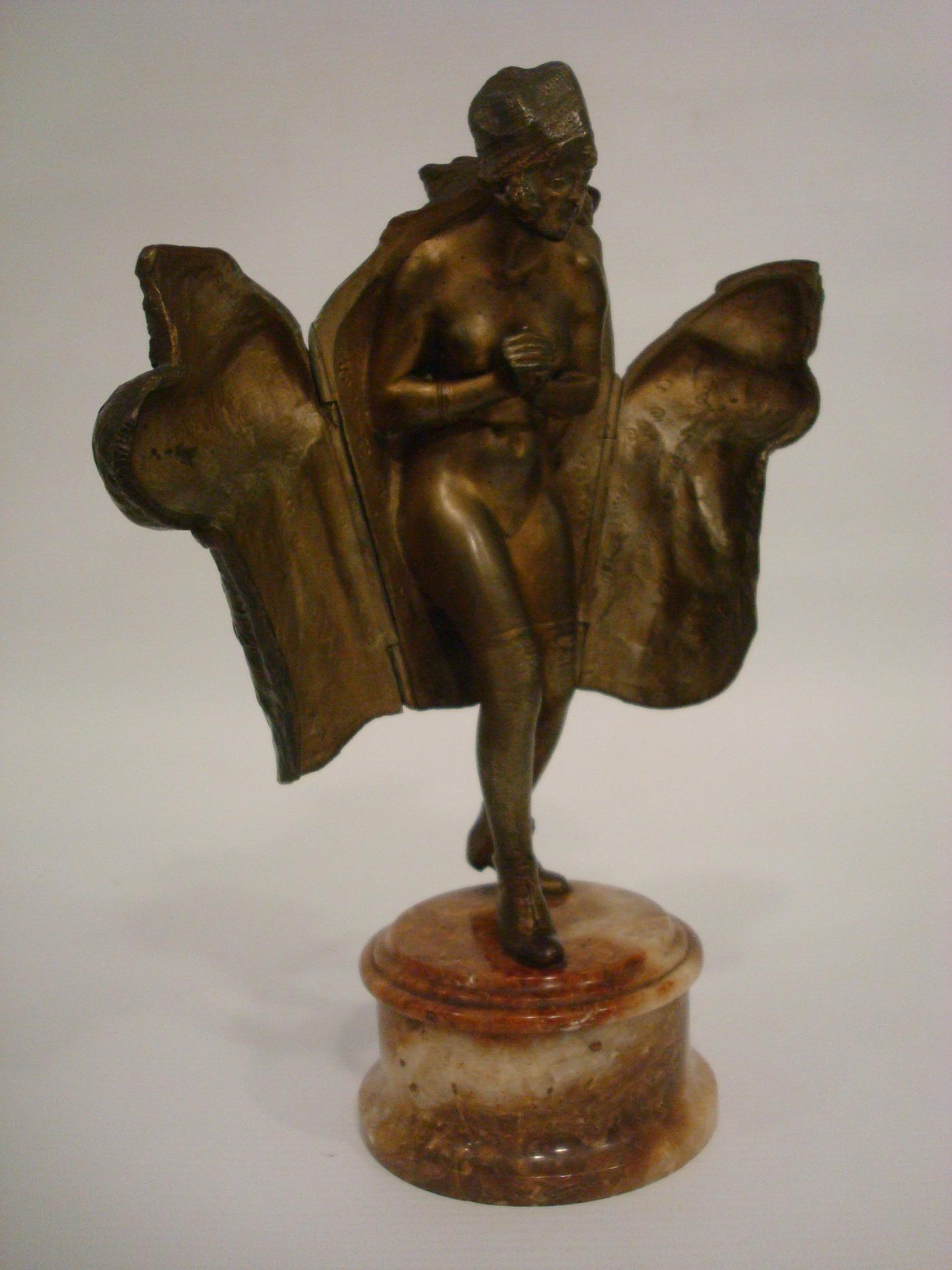 This has always been one of our favorite naughty bronzes. This lovely girl, wearing her finest fur coat, is willing to open it up to reveal her nude body. This bronze is in remarkable condition. We have owned other examples in our 27 years of